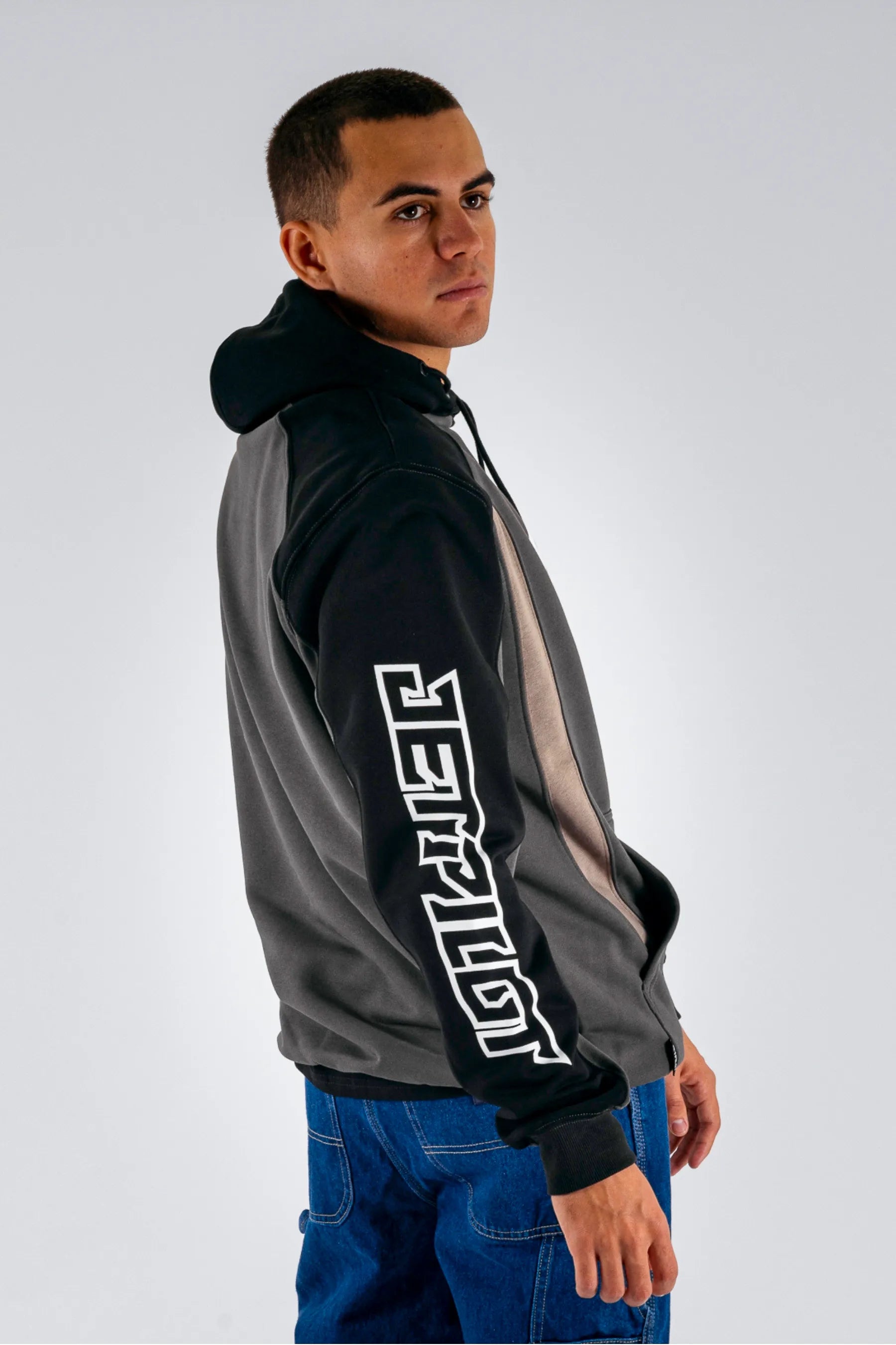 side view of a person wearing a black pullover with a white Jetpilot logo on a white background — view 5 (3)