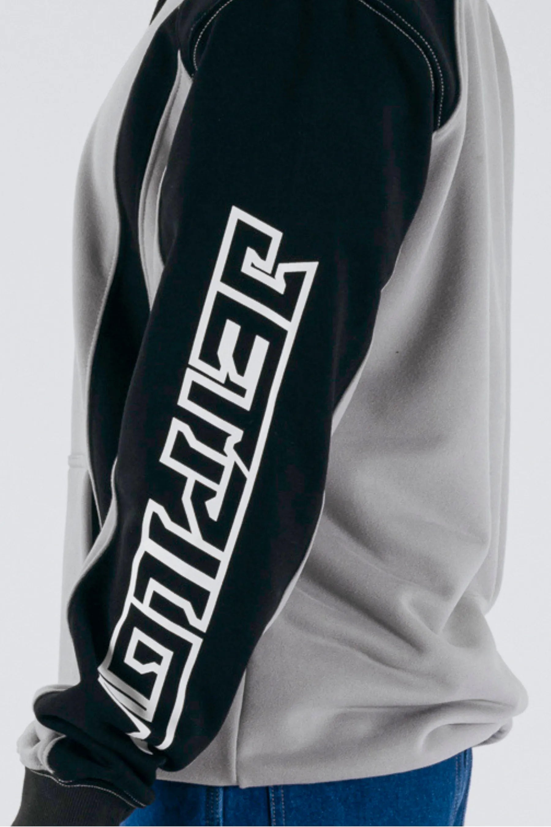 side view of a person wearing a grey/black pullover with a Jetpilot logo on a white background — view 4 (3)