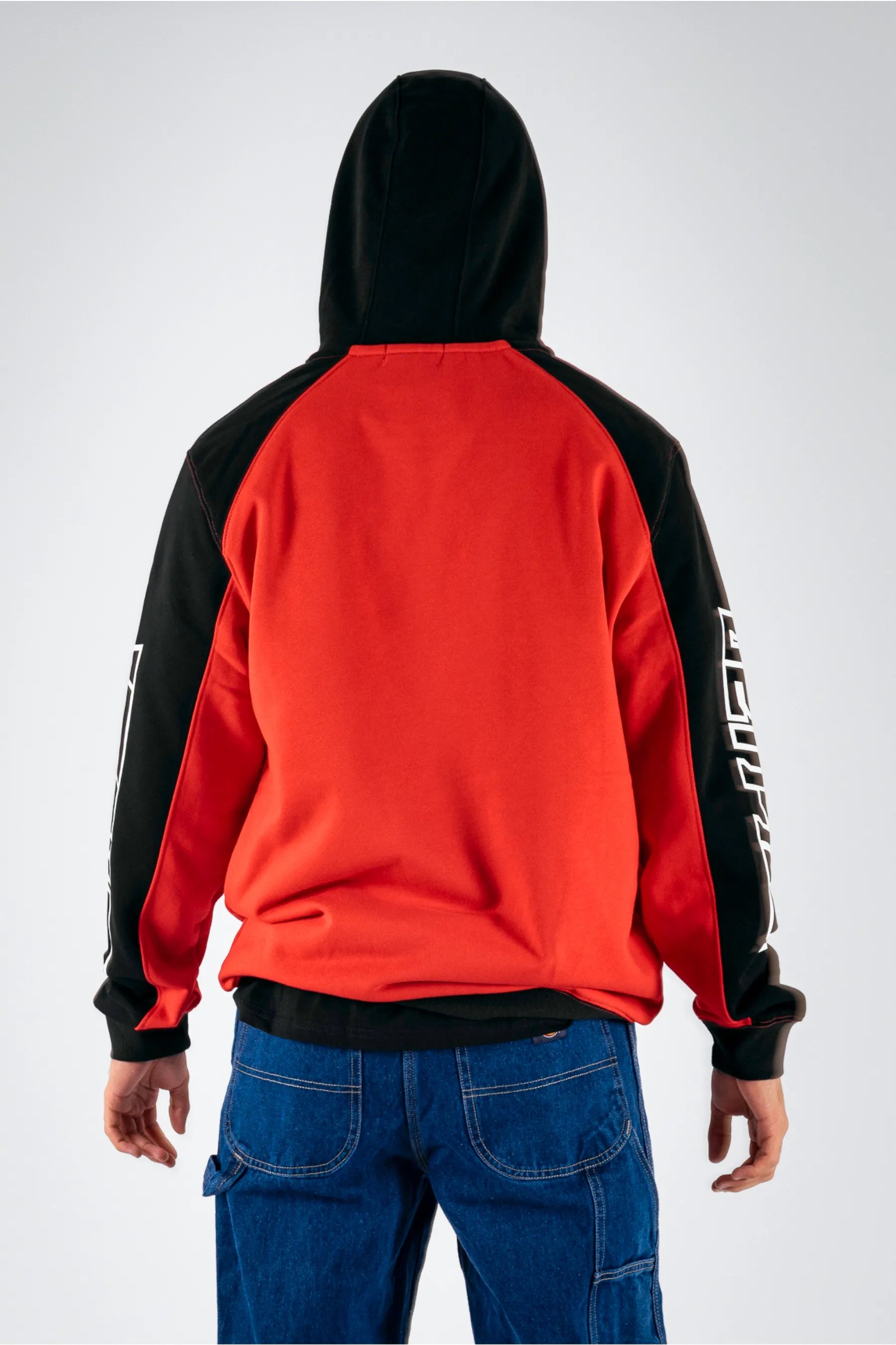 back view of a person wearing a black/red pullover on a white background — view 2 (3)