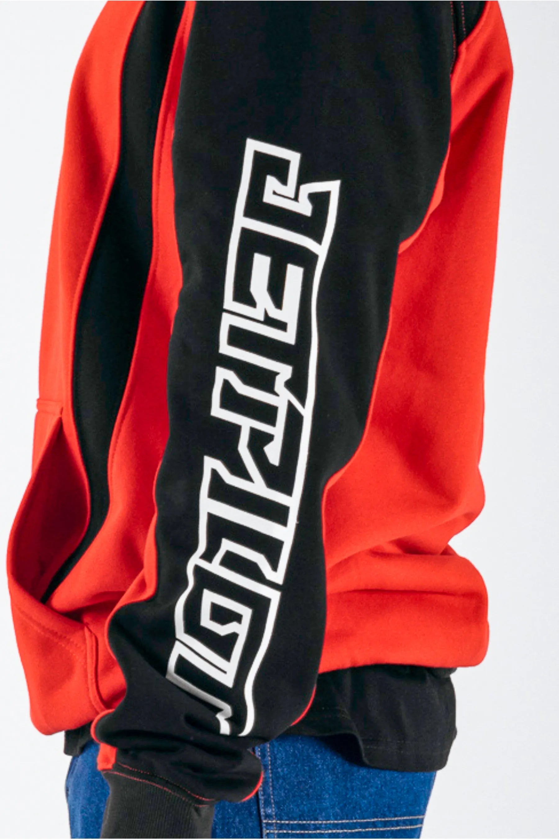 side view of a person wearing a black/red pullover with a white Jetpilot logo on a white background — view 3 (3)