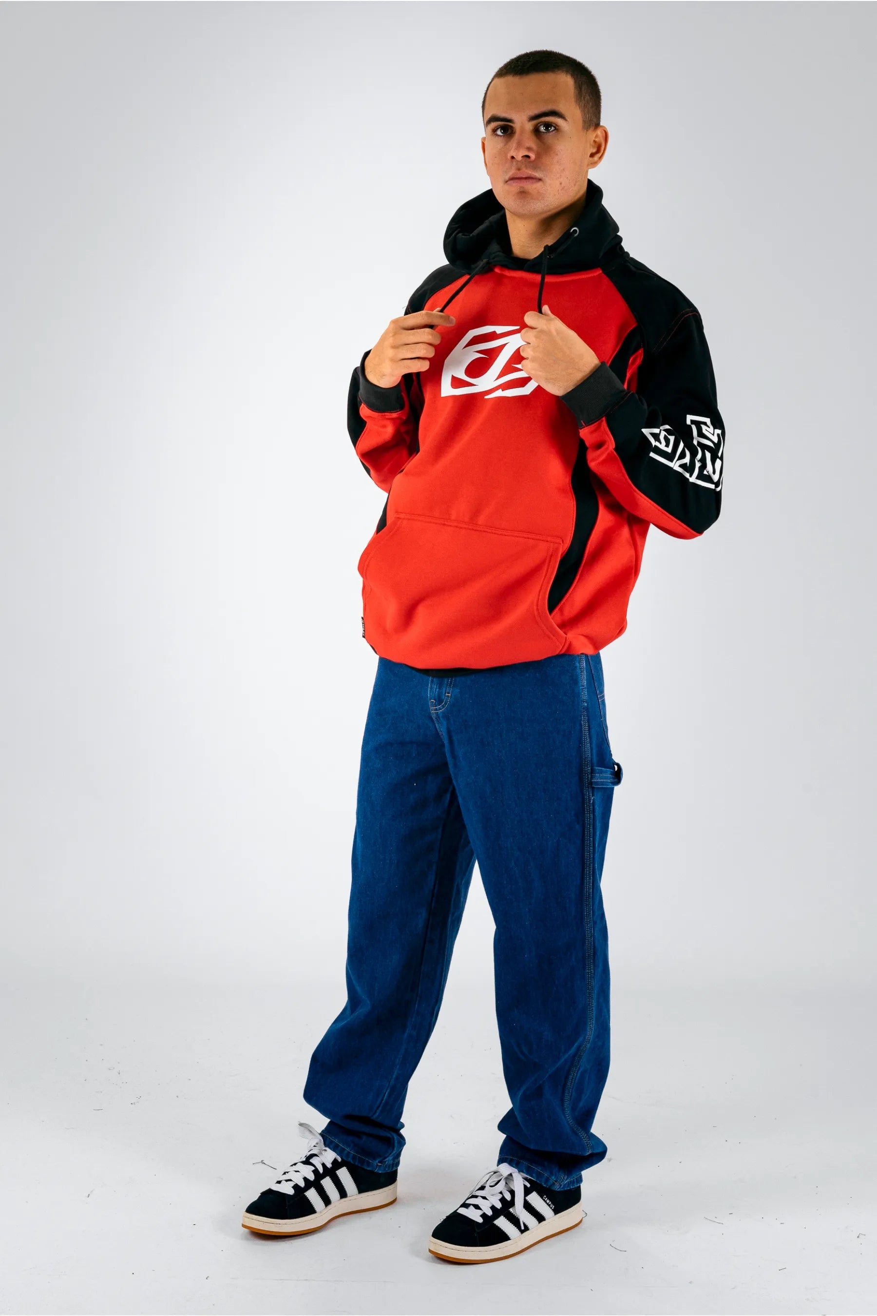 a person wearing a black/red pullover with a white Jetpilot logo, blue shorts and a black/white shoes — view 5 (3)