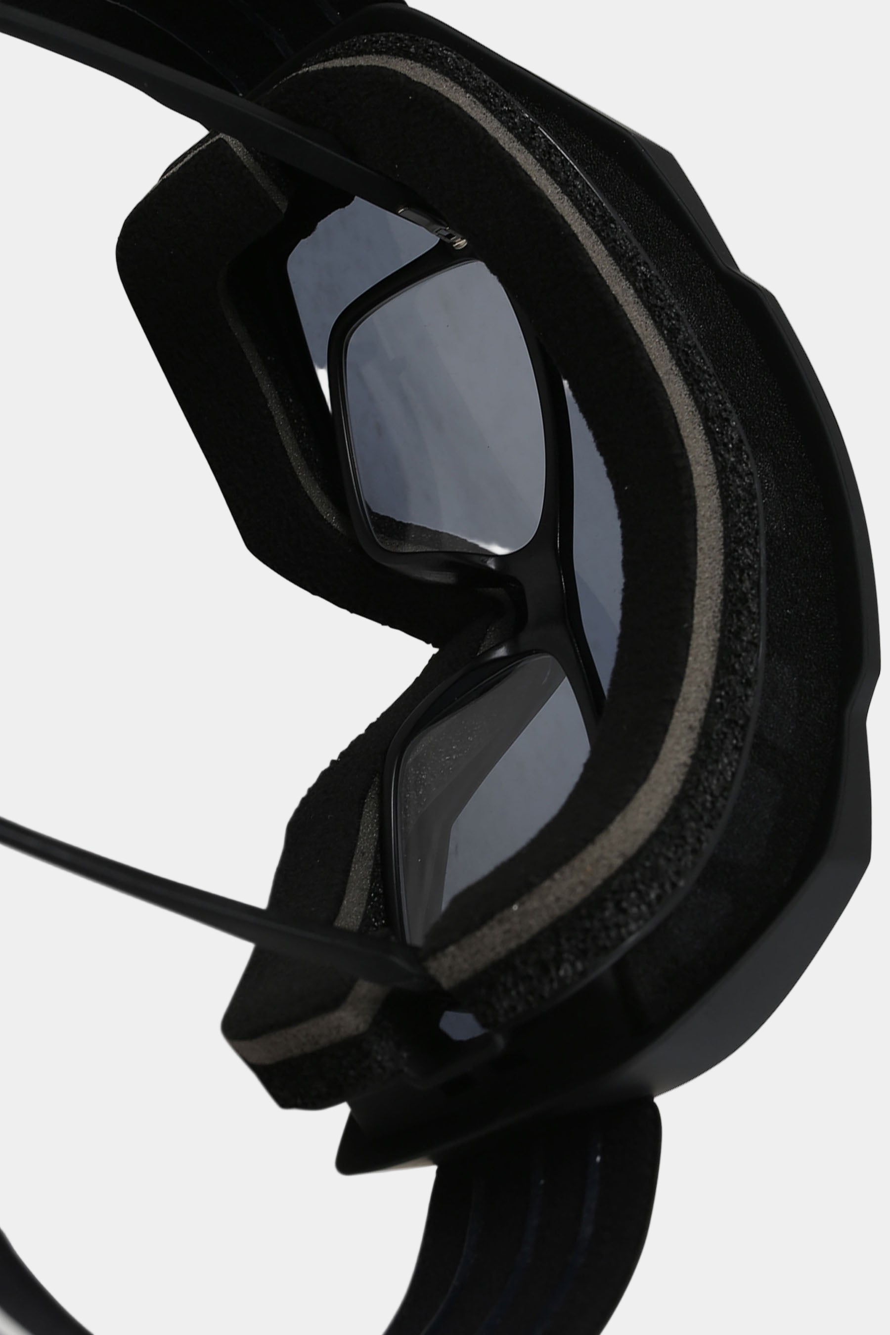 Black goggles with a reflective lens on a white background