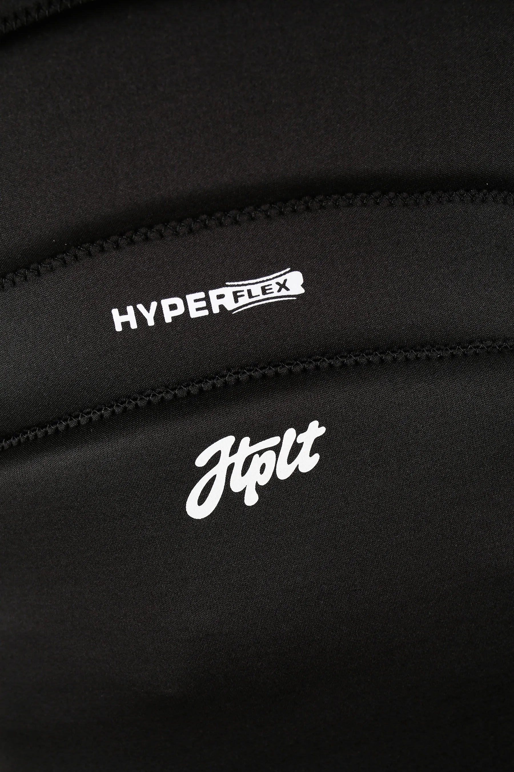 Close-up of black fabric with 'HYPERFLEX' and 'Jtplt' logos.