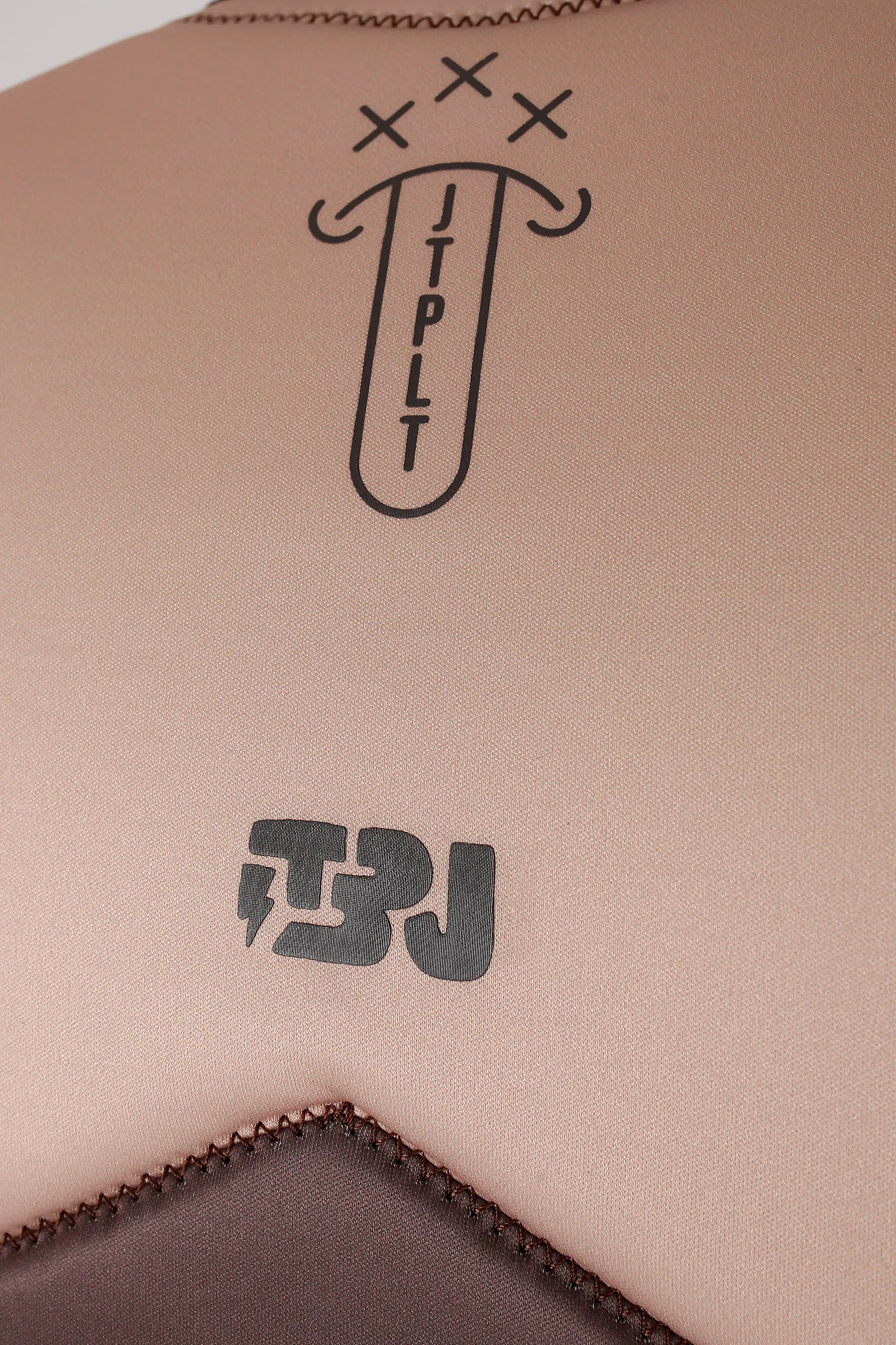 Close-up of Jetpilot X1 Life Jacket - JTPLT X Heatley - Brown with black text and logos.