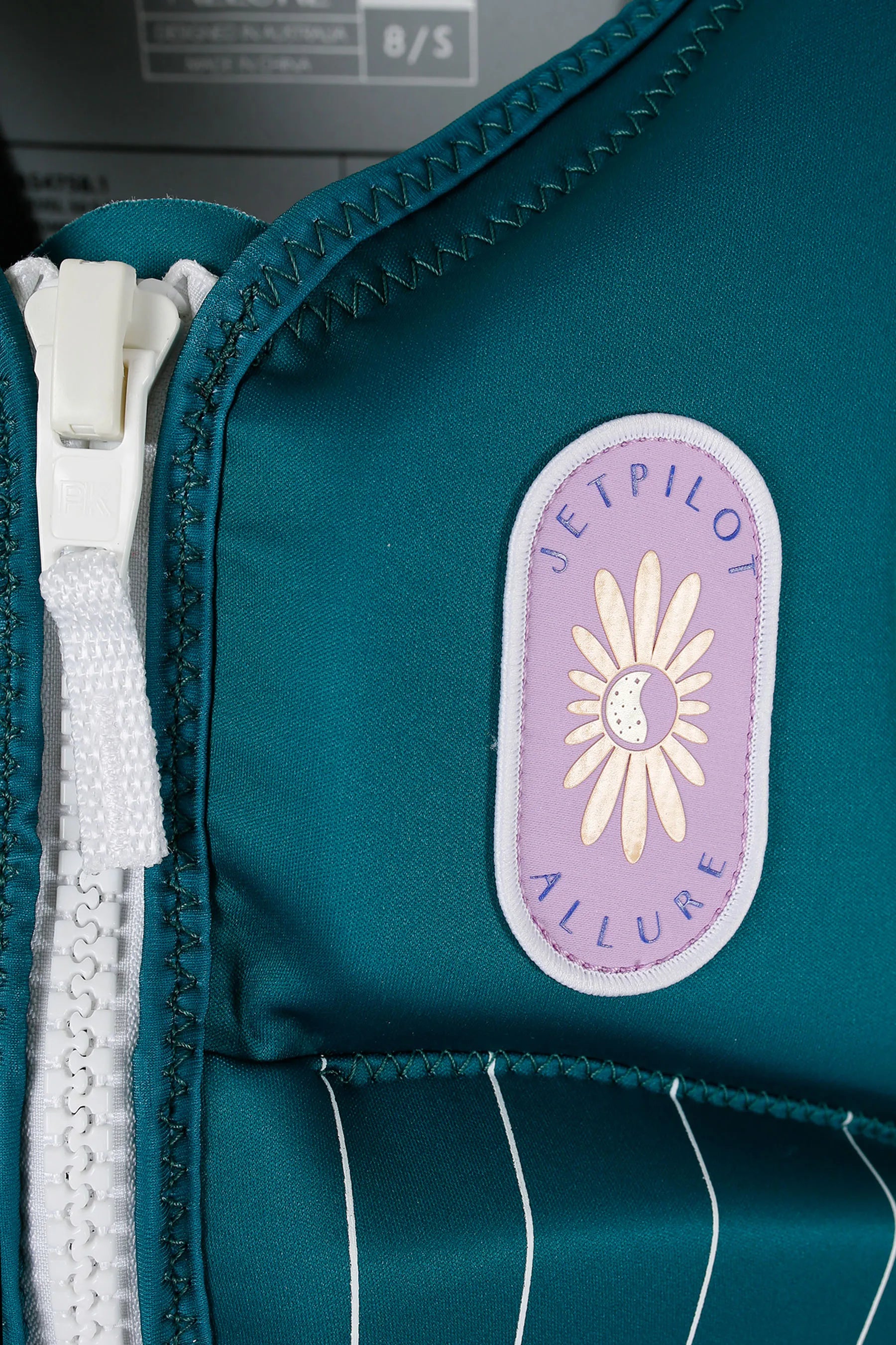 Jetpilot Allure Ladies Life Jacket - Green with lavender patch, floral designs and blue "Jetpilot" branding