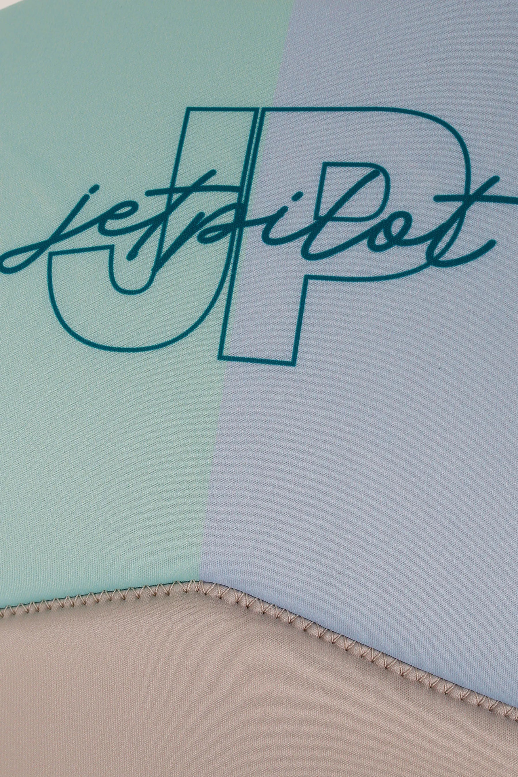Close-up of a product with 'jetpilot' branding on a multicolored background