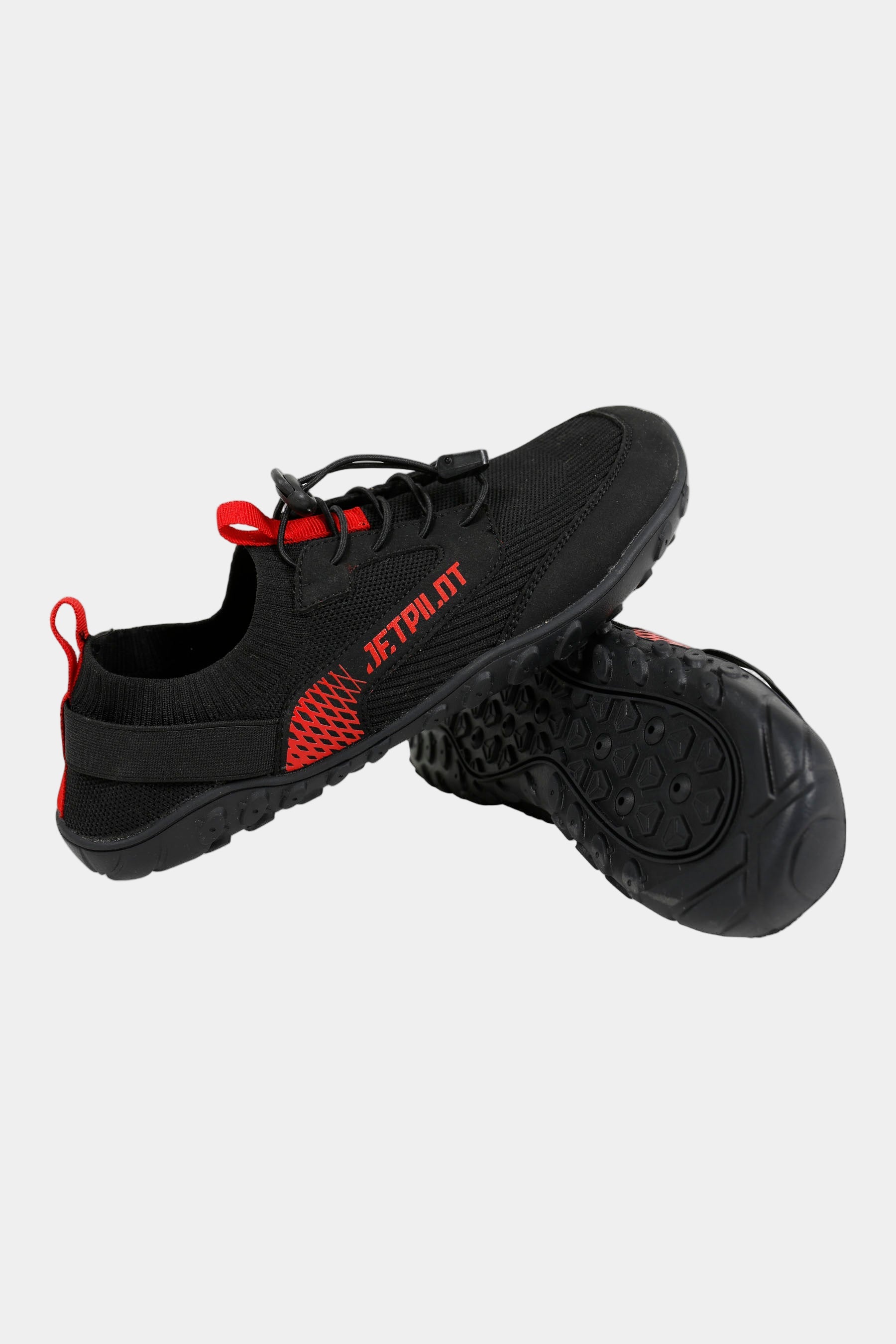 Black and red watersports reef shoes with 'JETPILOT' branding on a light gray background