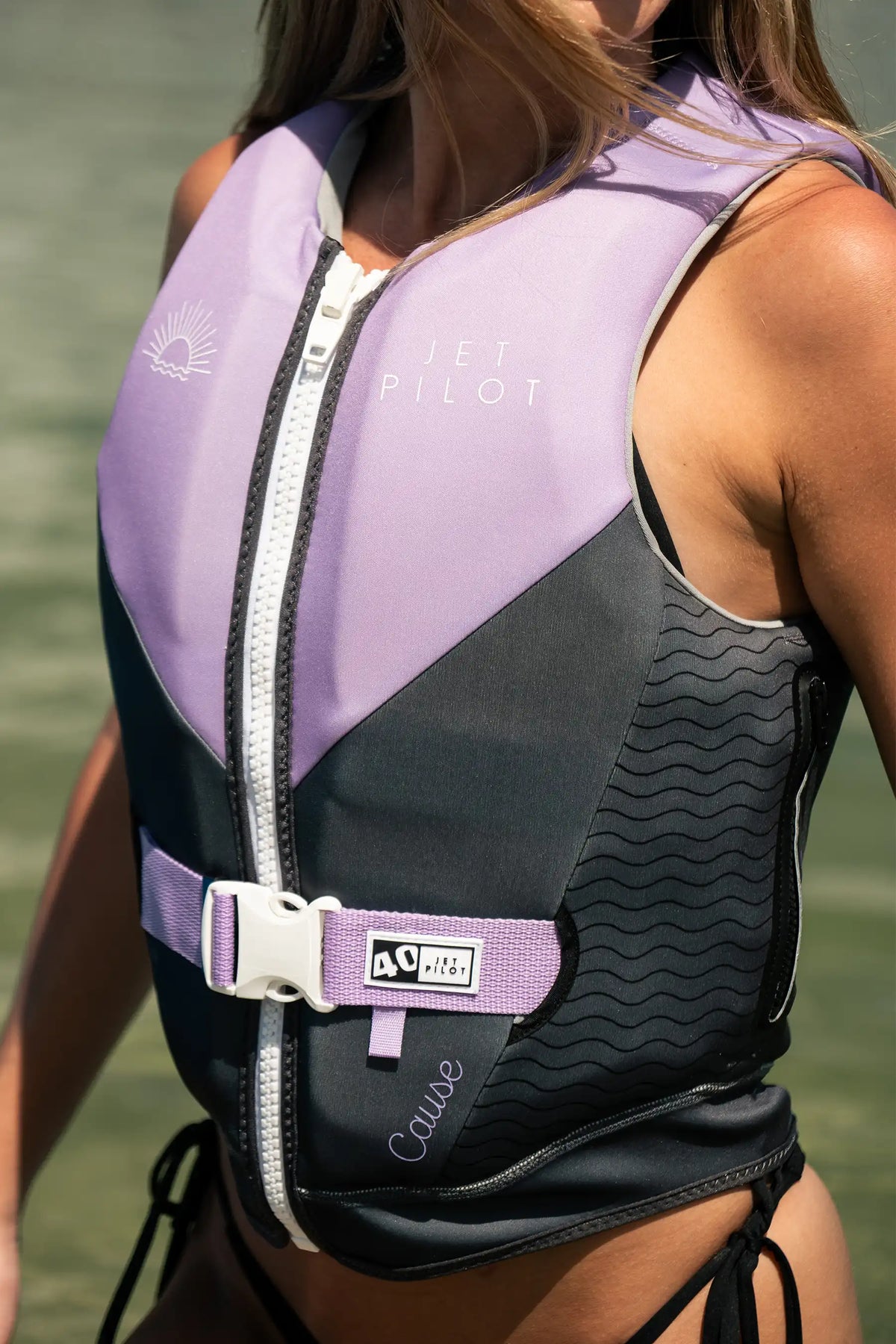 Close-up of the Purple Cause Ladies on a model, showing the white zip, purple waist strap and 40 tab