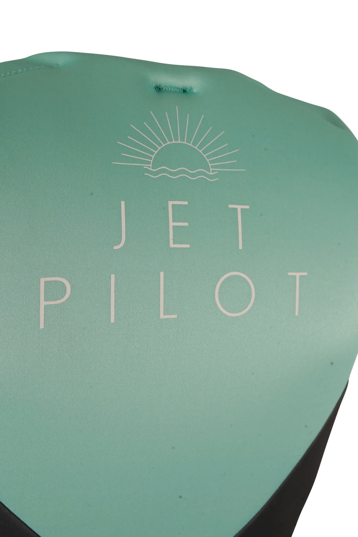 Close-up of the sunrise graphic and Jetpilot lettering on the upper back of the Teal Cause Ladies