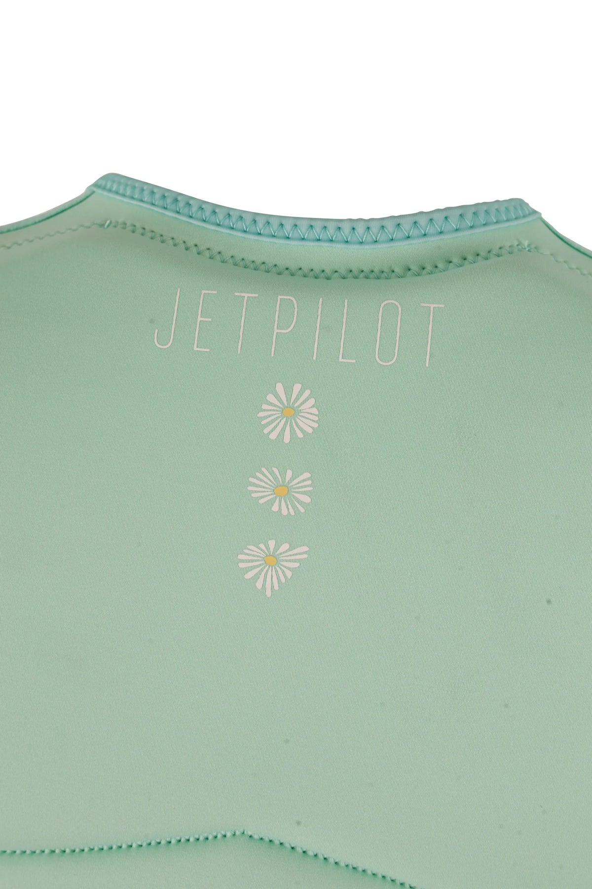 Close-up of the Jetpilot name and three yellow-centred daisies on the back of the Teal Isla