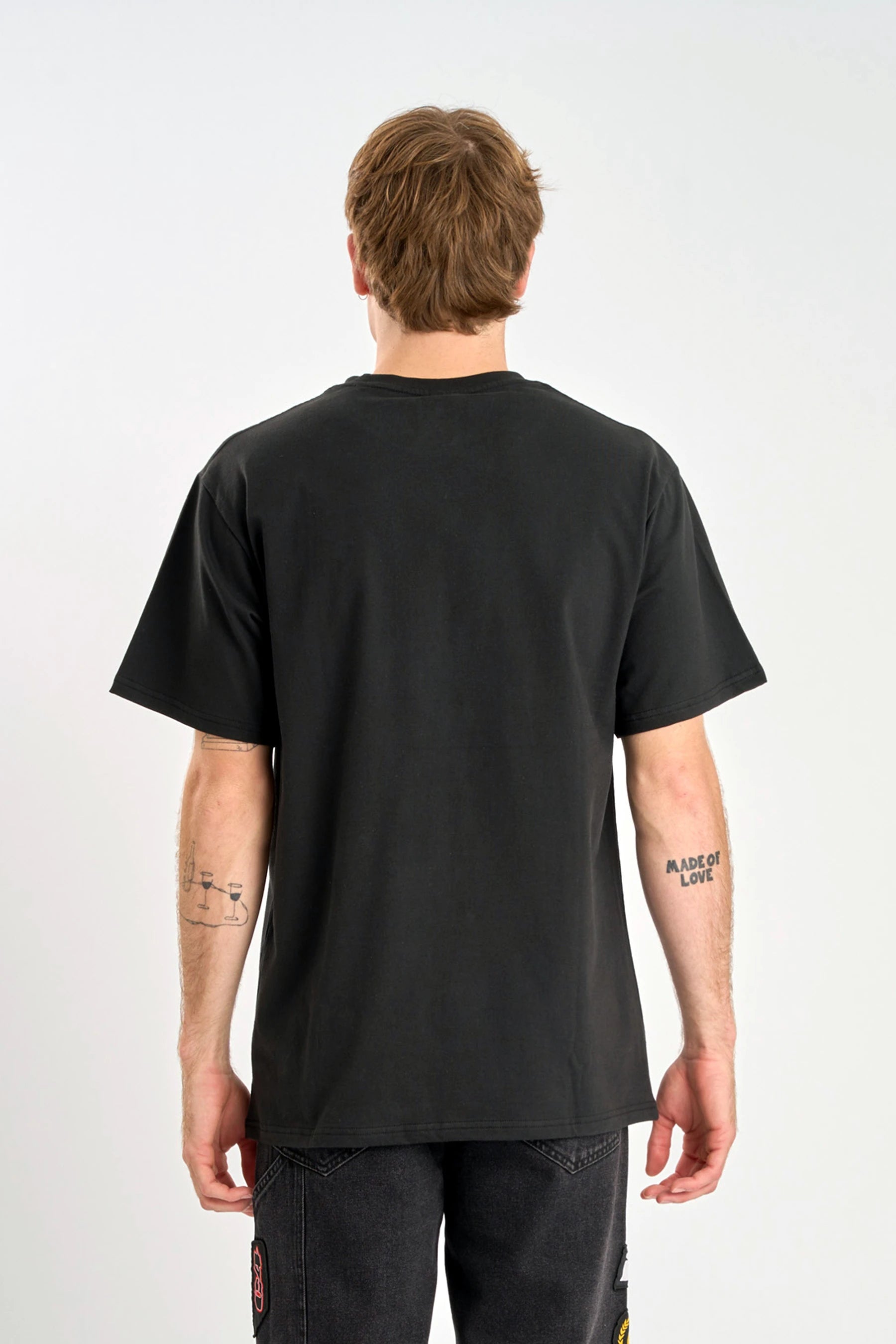 Person wearing a Jetpilot Pulse Streamliner Tee - Black t-shirt with text on sleeves against a white background — image 2