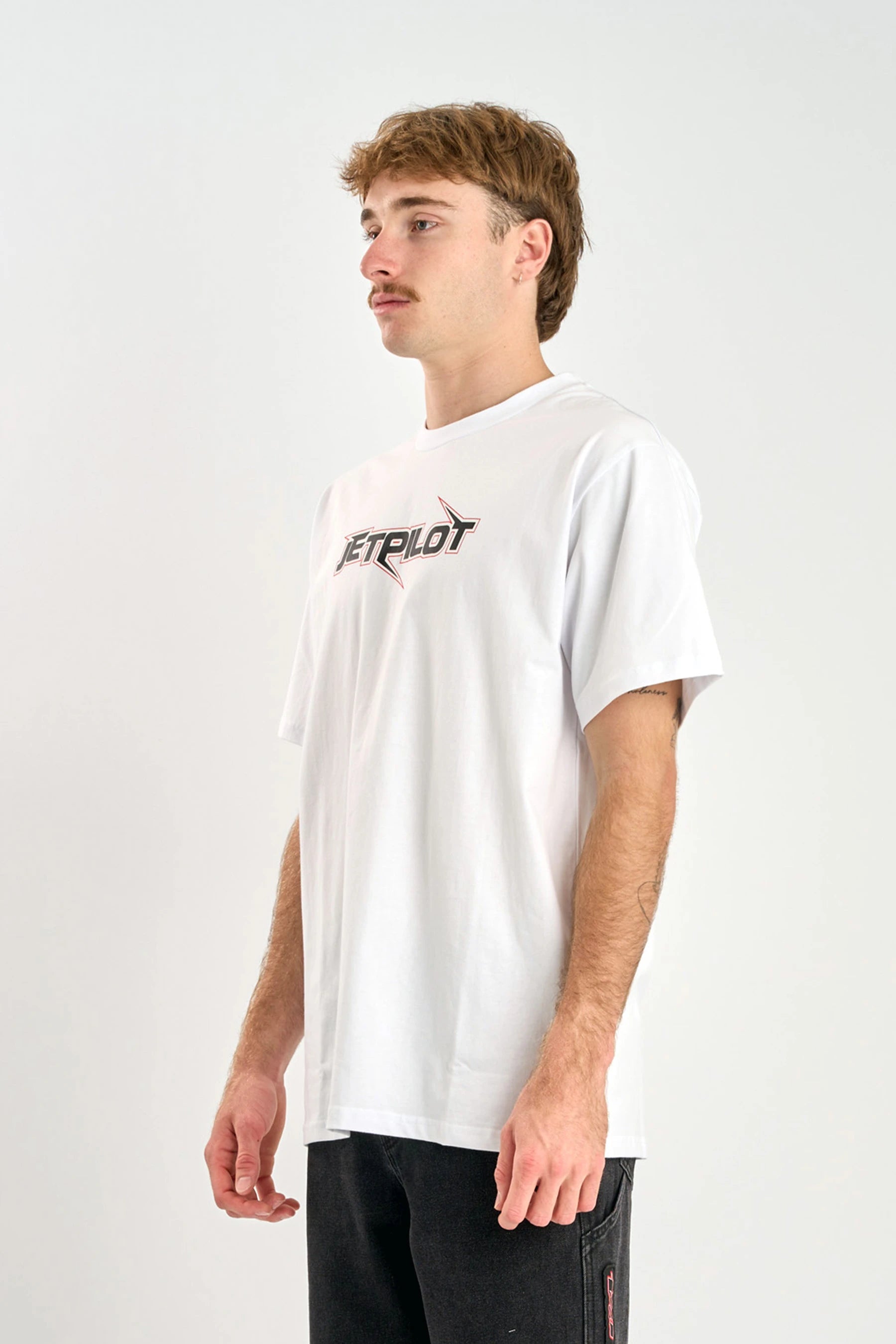 Person wearing a Jetpilot Raptor Tee - White t-shirt with a logo on a plain background — image 2