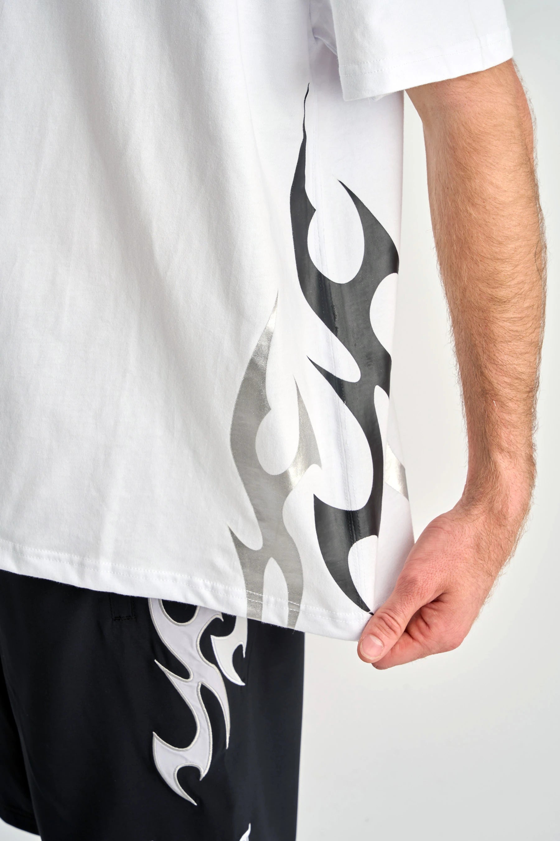 Person wearing a Jetpilot Tribal Heavy Tee - White with black and metallic grey tribal design on a plain background — image 2