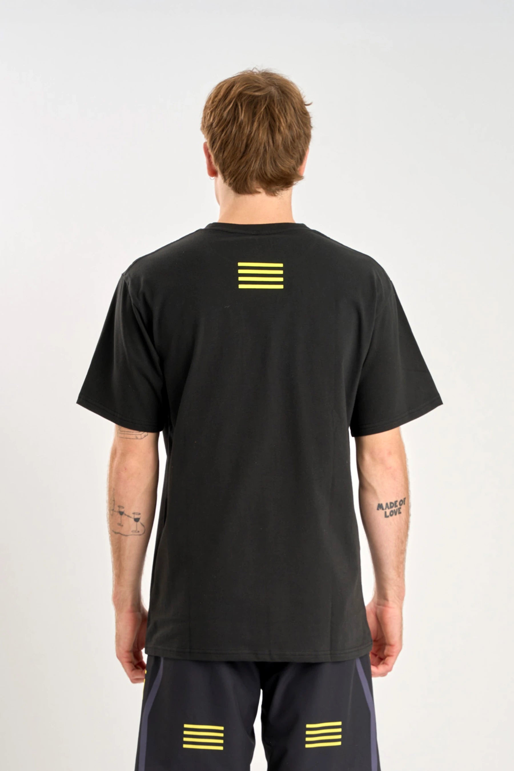 Person wearing a Jetpilot Vault SS Tee - Black with yellow stripes on a white background — image 2