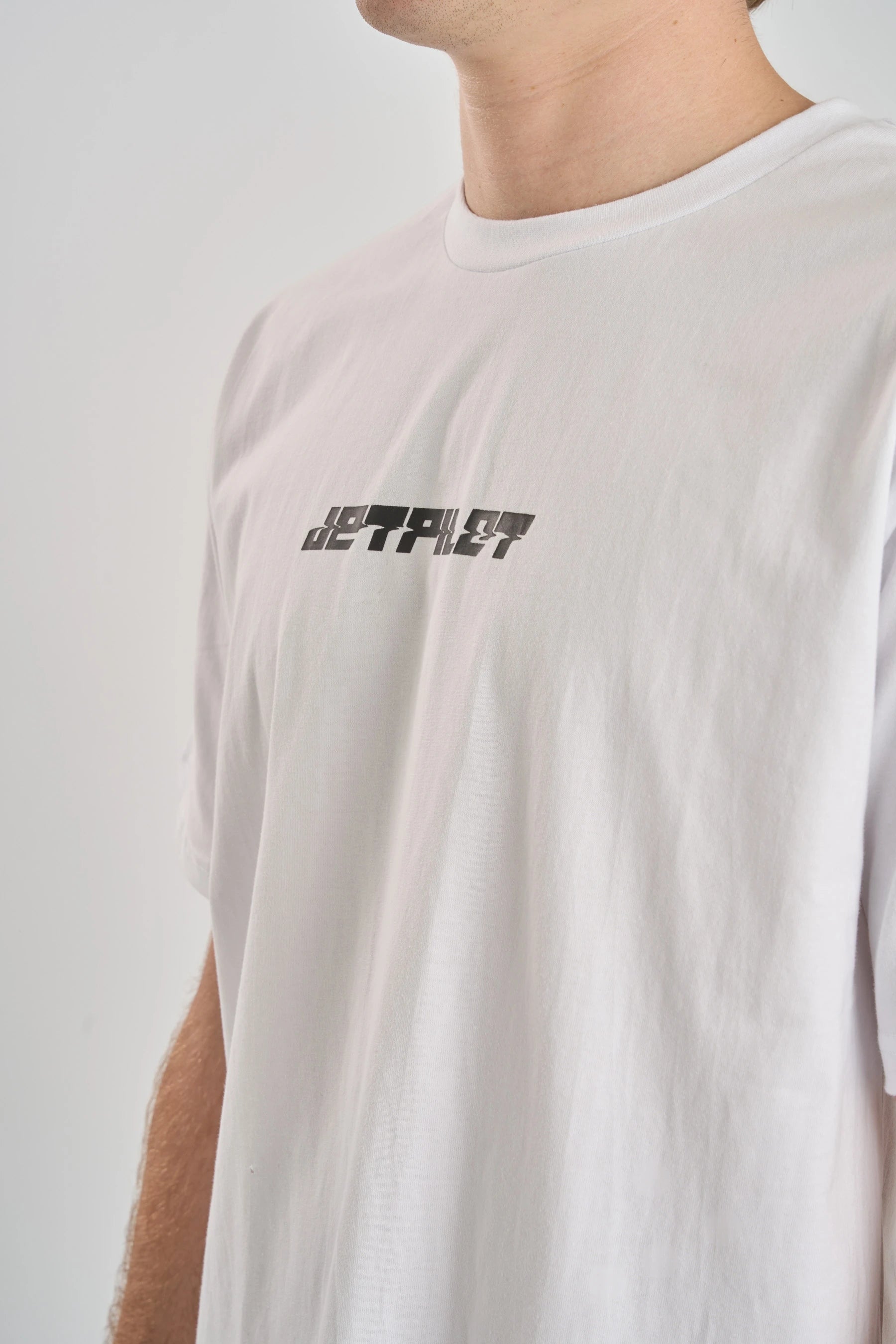 Up close White t-shirt with a brand logo on a plain background — image 2
