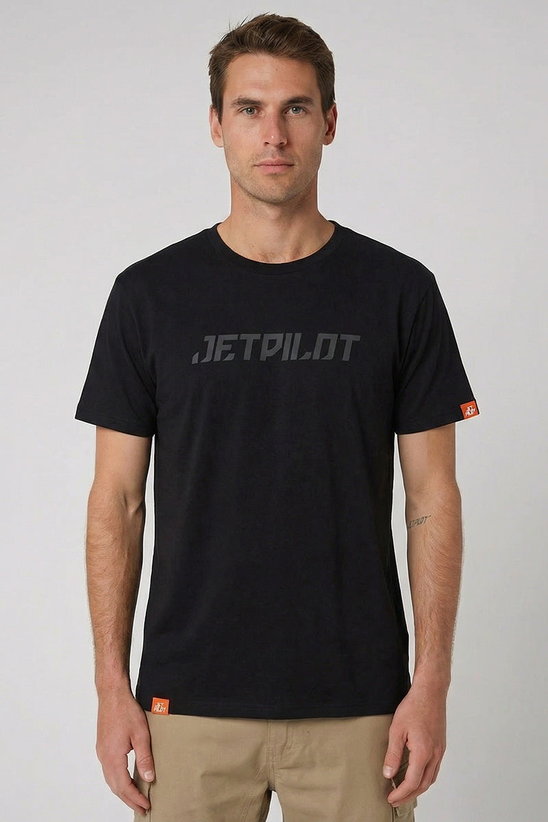 Man wearing a black t-shirt with 'JETPILOT' logo on a gray background