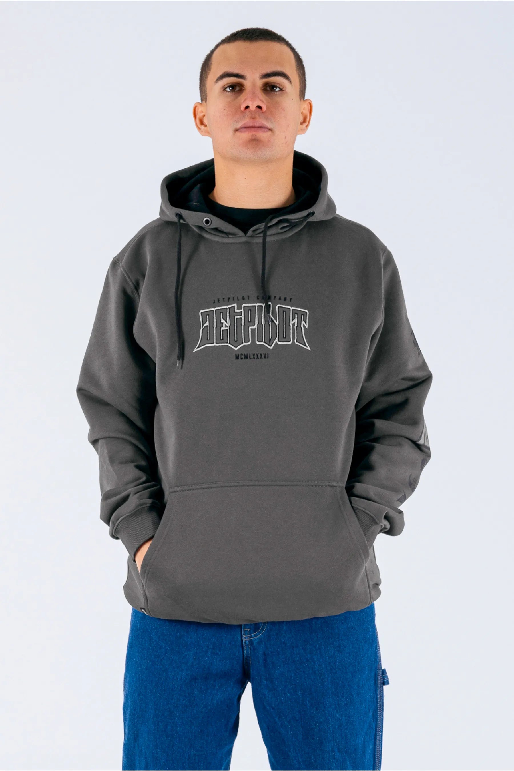 front view of a person wearing a charcoal pullover with a Jetpilot logo on a white background — view 1 (5)
