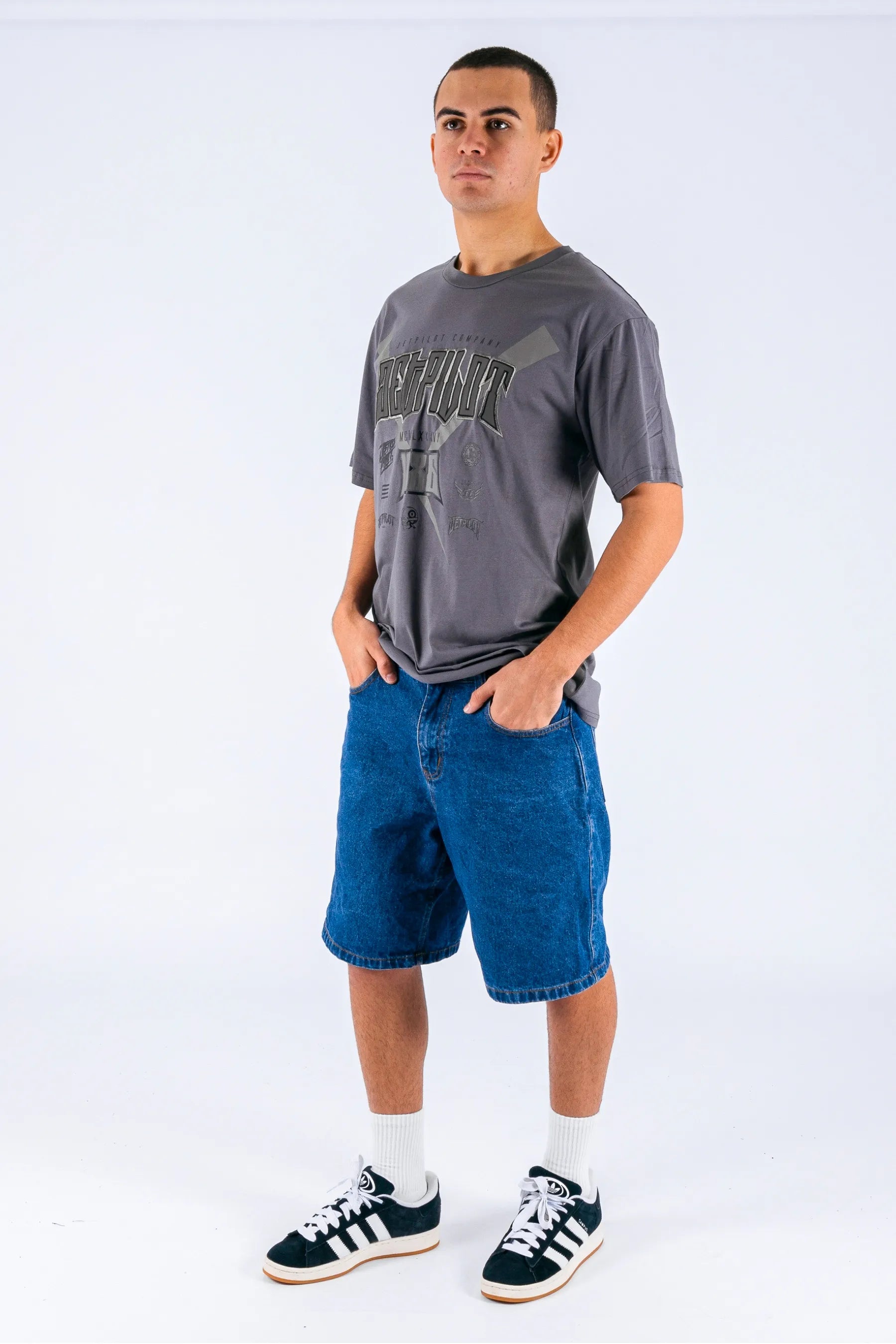 A person wearing a charcoal tee with a Jetpilot logo on a white background — view 5 (3)