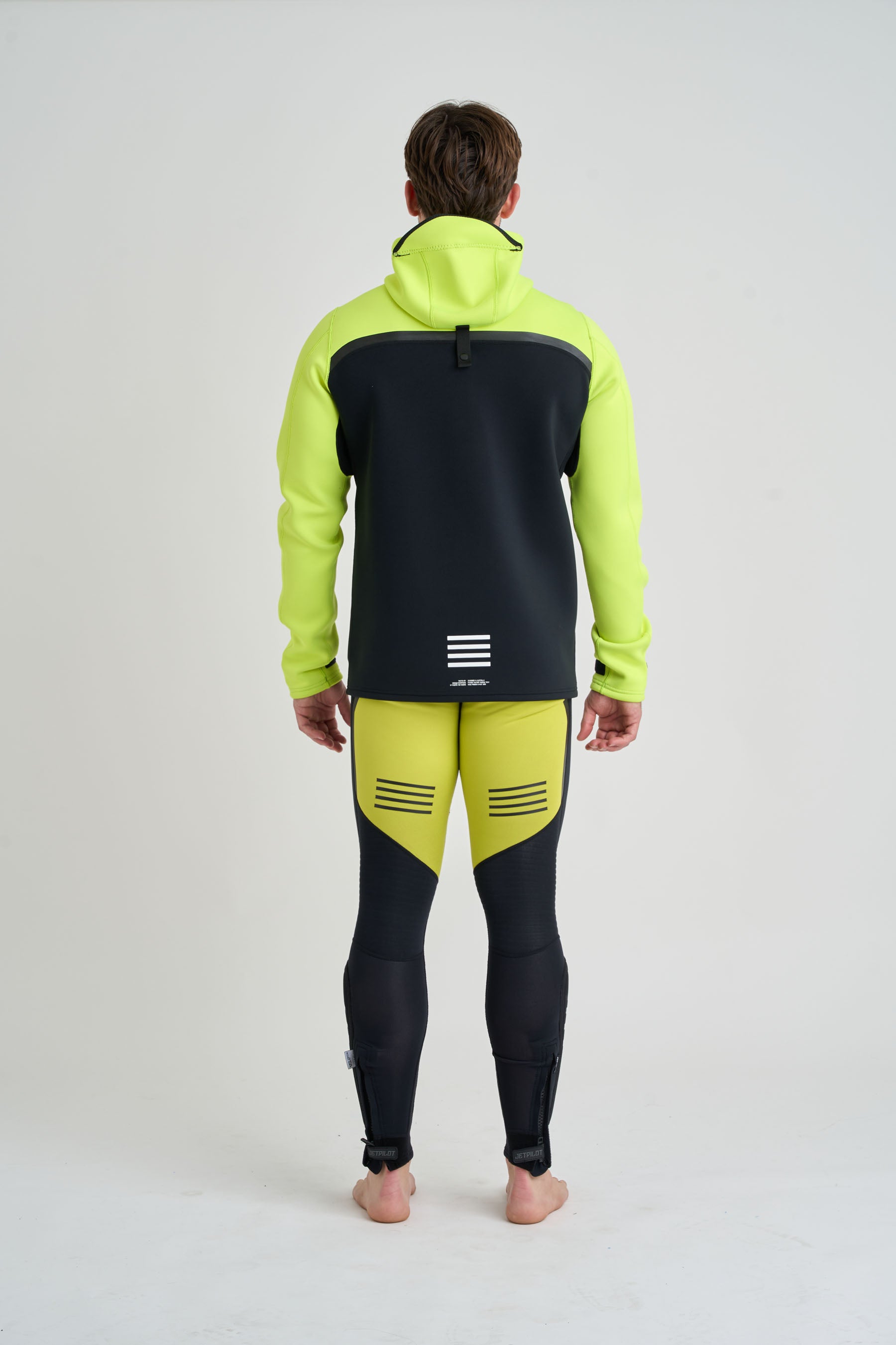 Person wearing a bright yellow and black outfit on a white background