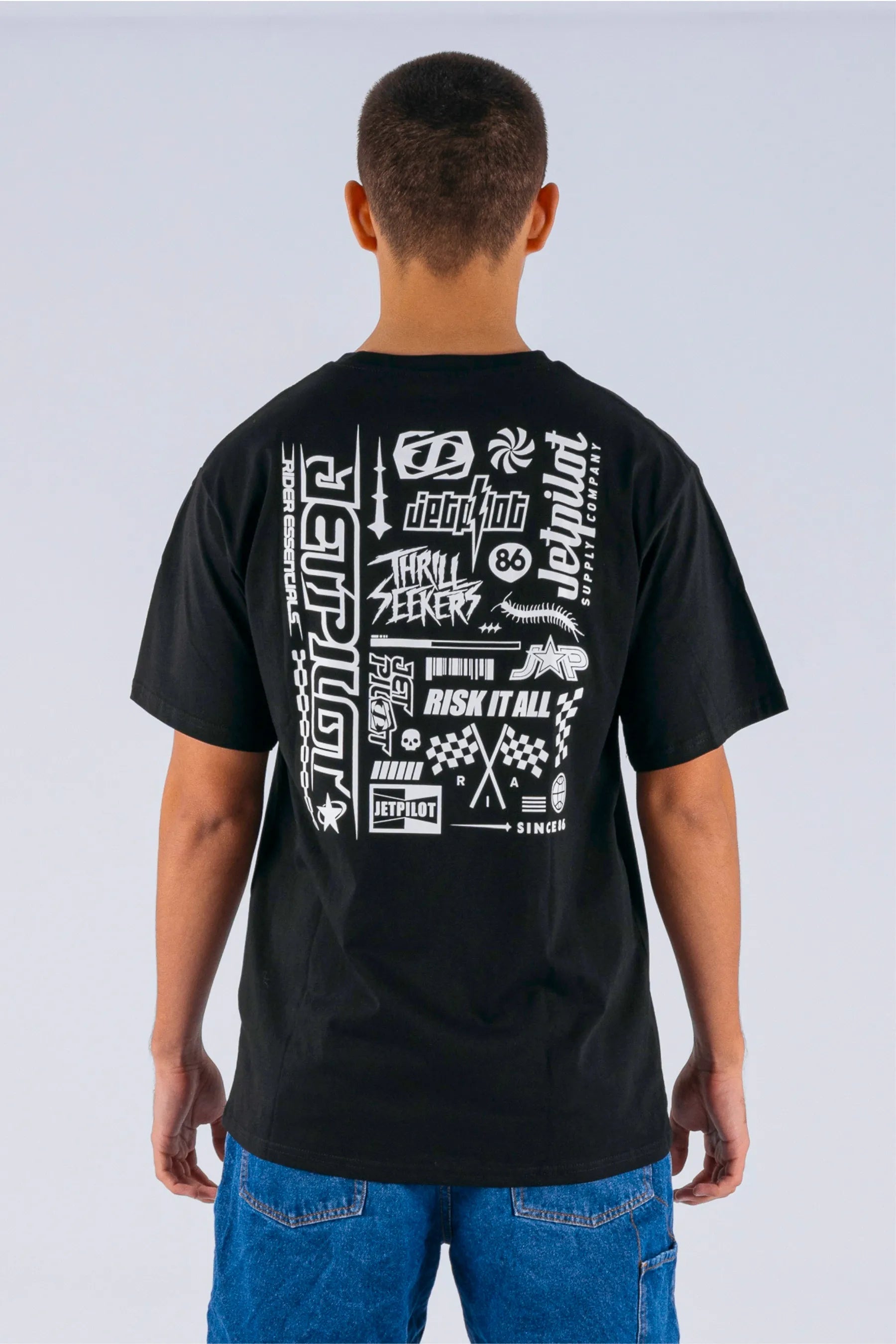 back view of a person wearing a black tee with Jetpilot logos on a white background — view 2 (4)