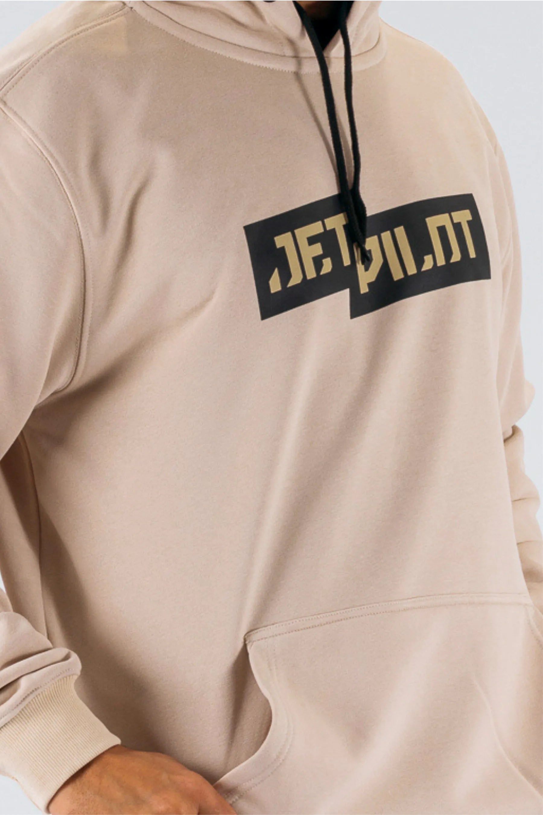 Close up of a person wearing a cement pullover with a Jetpilot logo — view 5 (3)