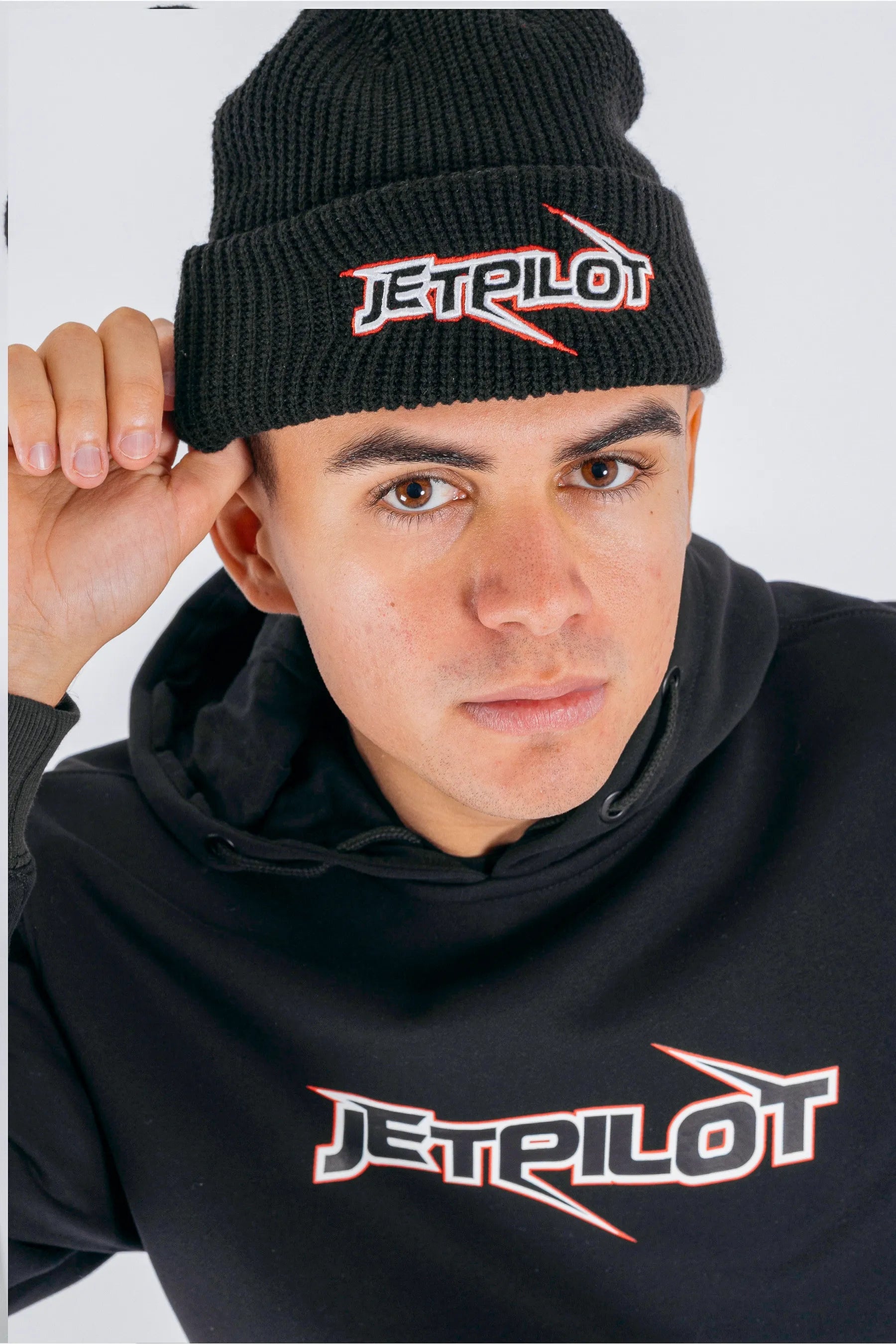Front view of a person wearing a black beanie with Jetpilot logo on a white background — view 1 (3)