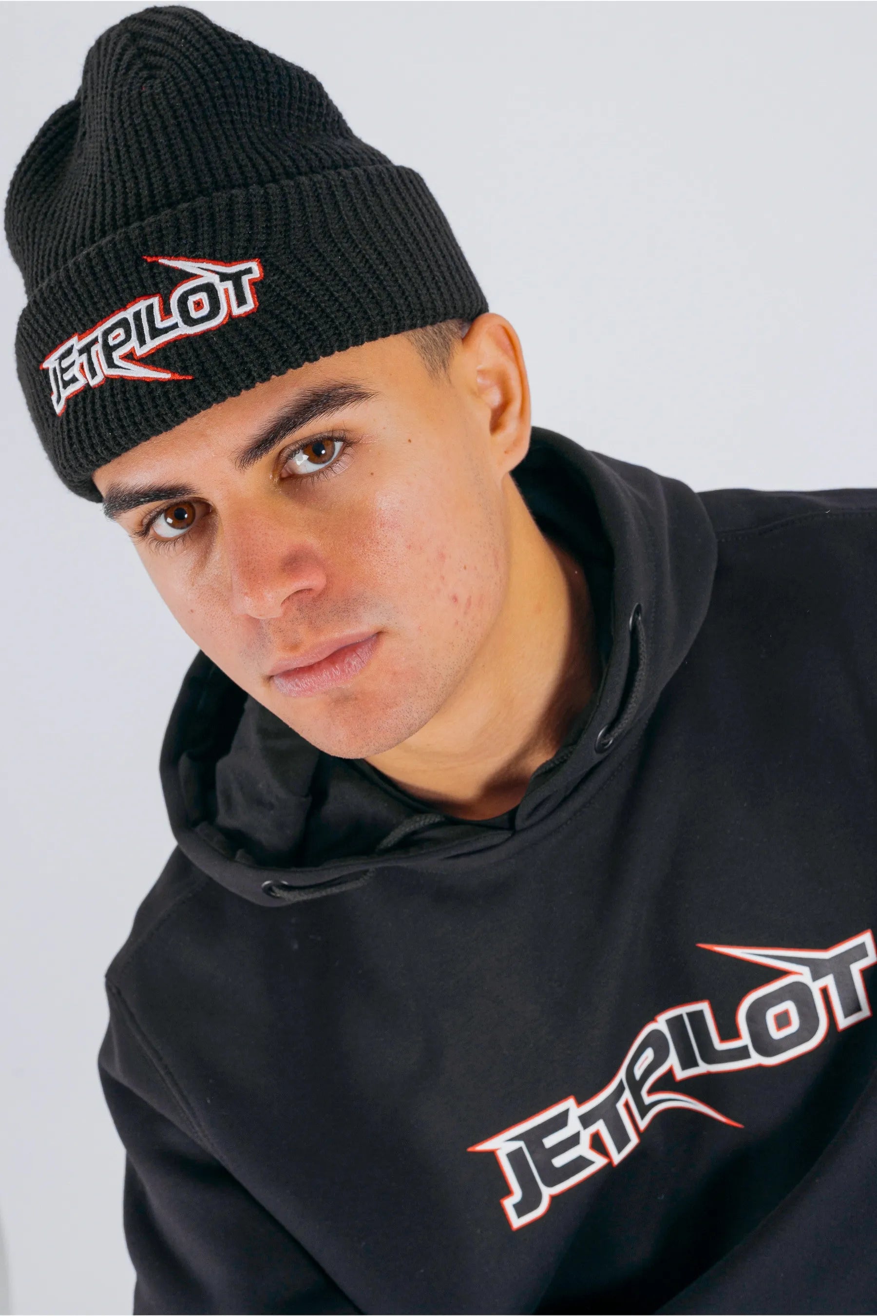 High view of a person wearing a black beanie with Jetpilot logo on a white background — view 3 (3)