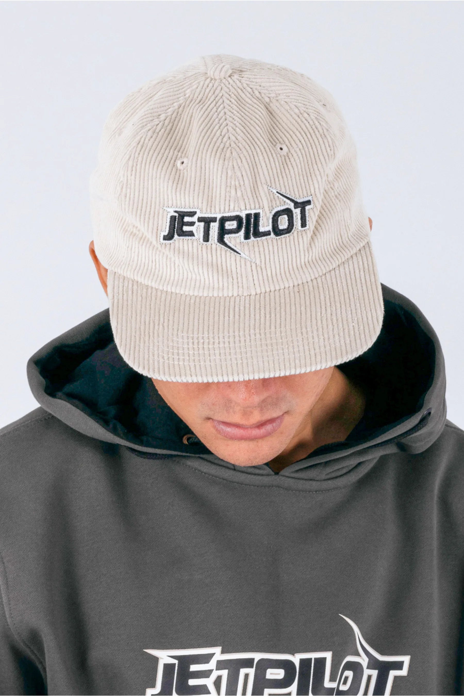 Close up of a person wearing a cement corduroy panel with a Jetpilot logo on a white background — view 3 (3)