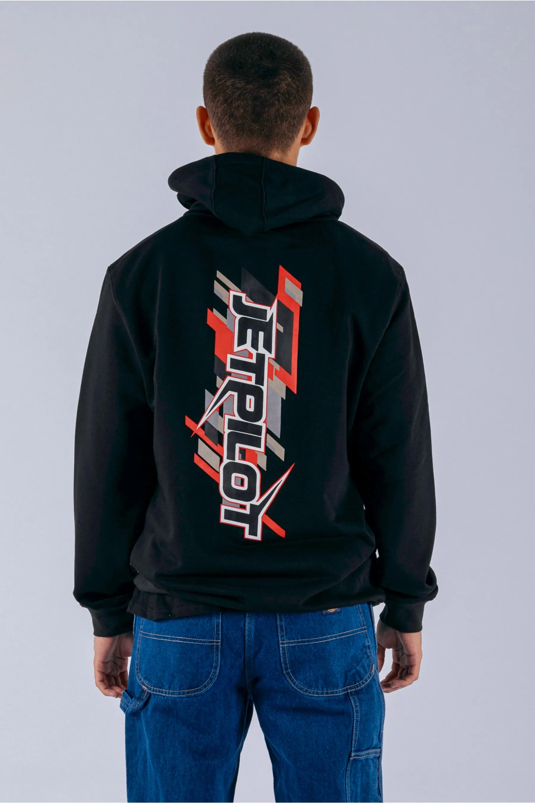 back view of a person wearing a black pullover with a Jetpilot logo on a white background — view 2 (3)