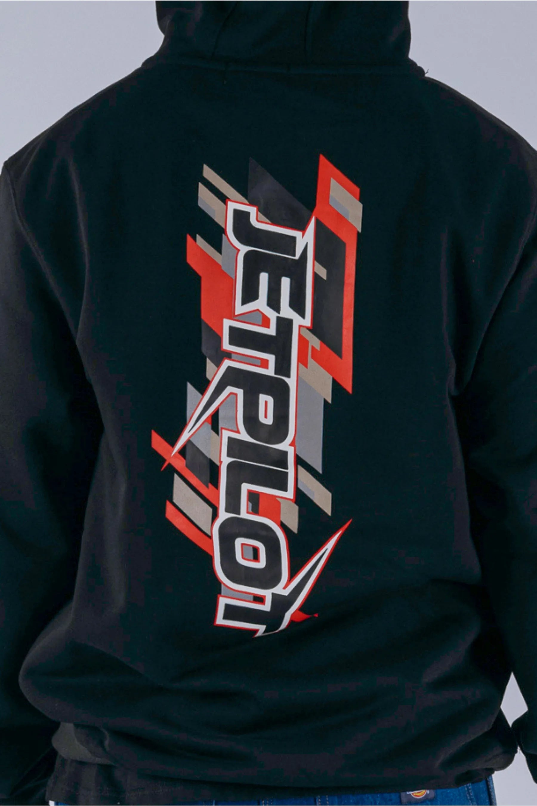 close up of a person wearing a black pullover with a Jetpilot logo on a white background — view 3 (3)