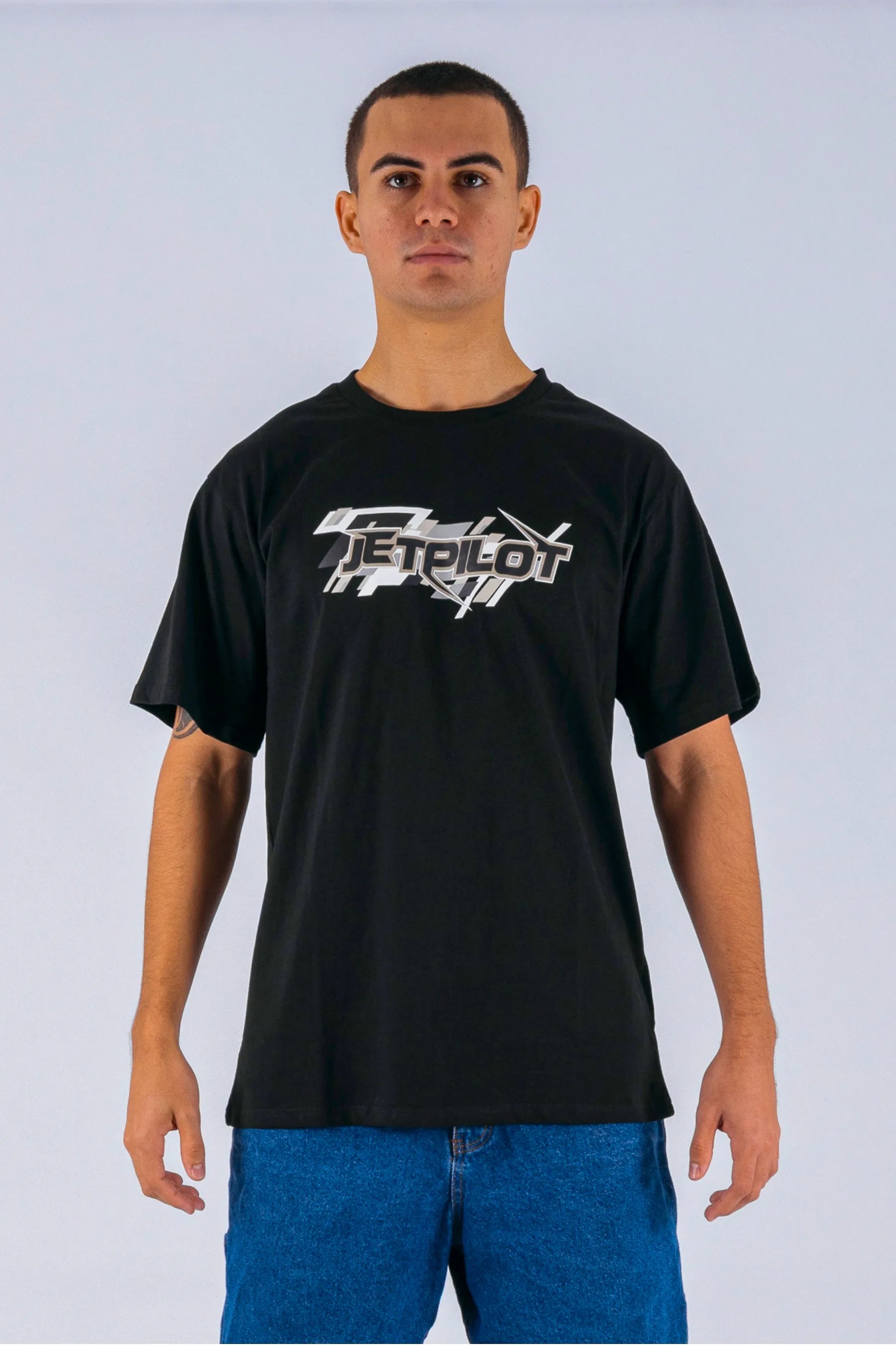 Front view of a person wearing a black tee with a Jetpilot logo on a white background — view 1 (5)