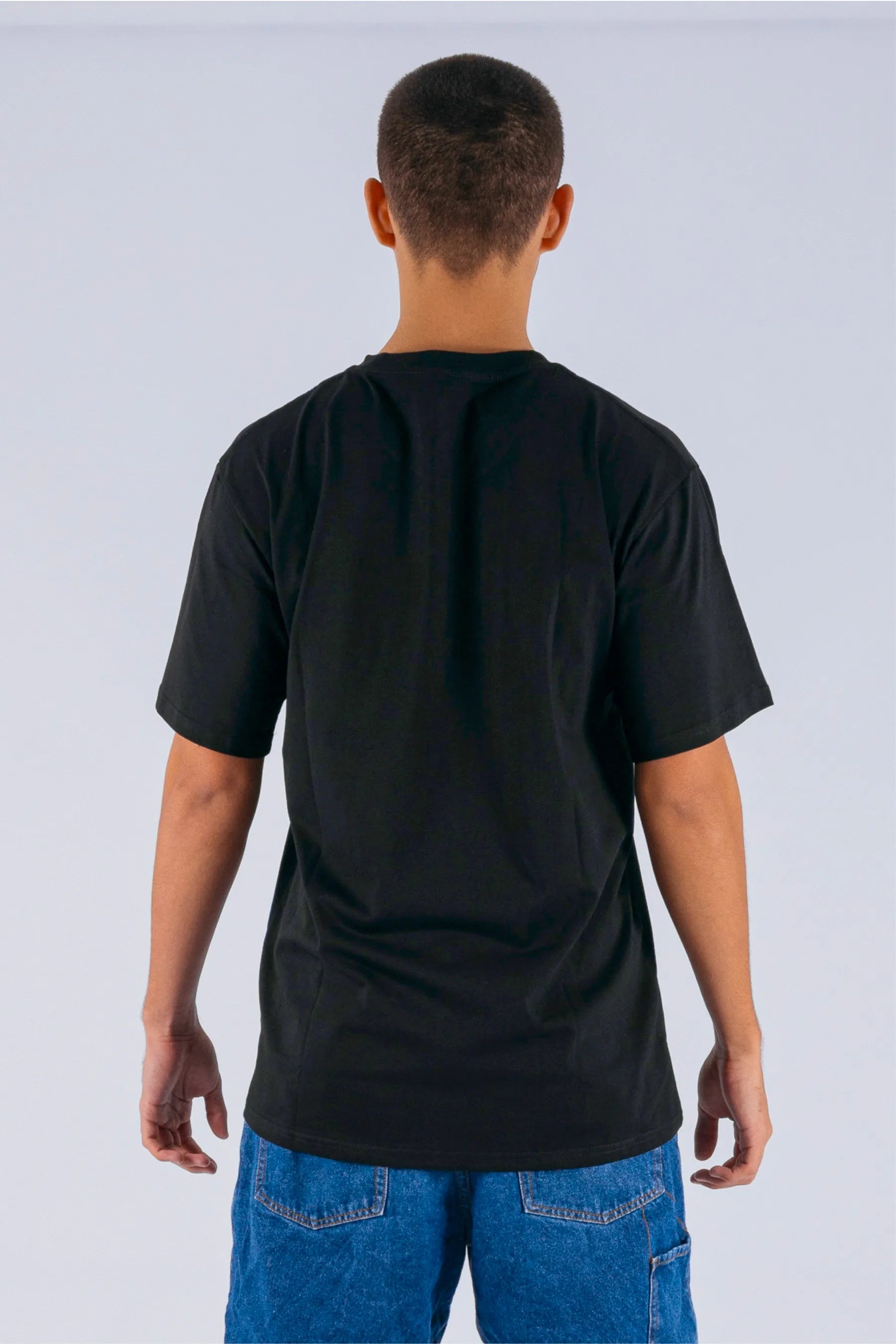 Back view of a person wearing a black tee on a white background — view 2 (3)