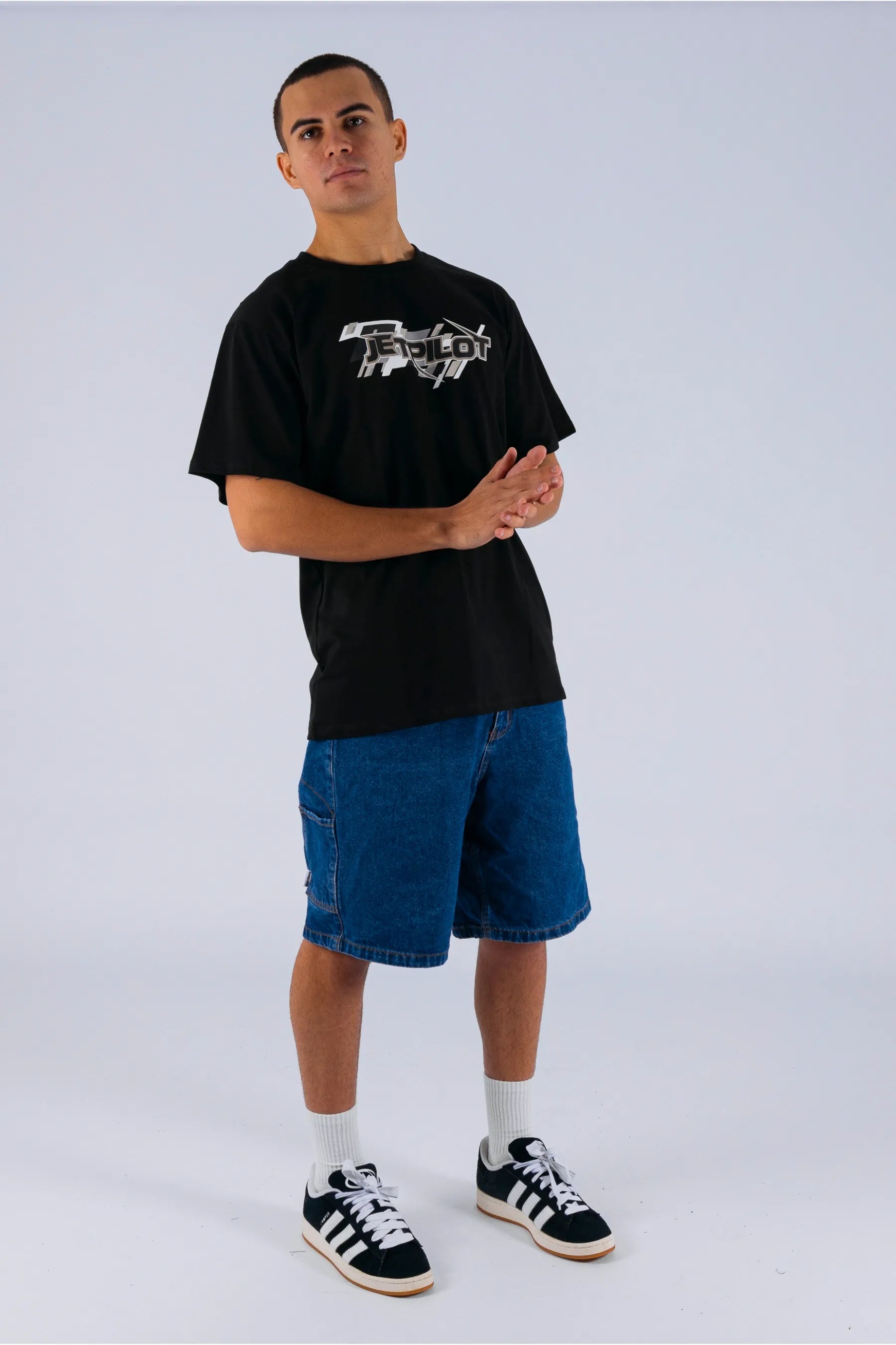 A person wearing a black tee with a Jetpilot logo on a white background — view 3 (4)
