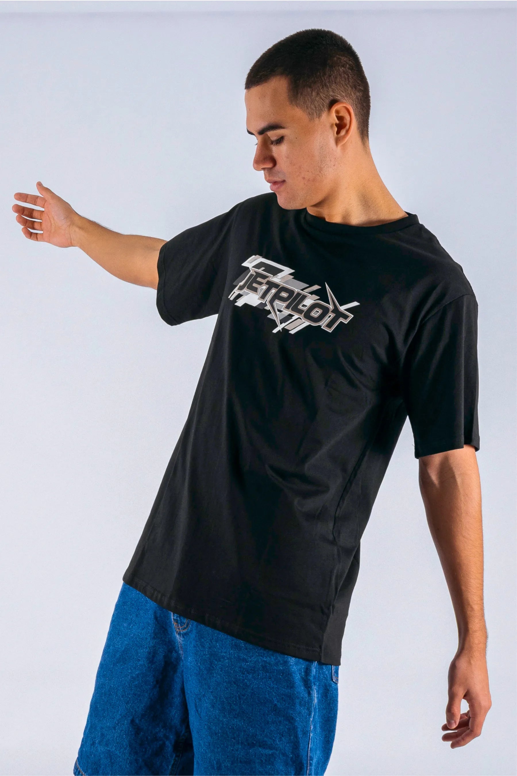 angled view of a person wearing a black tee with a Jetpilot logo on a white background — view 4 (3)