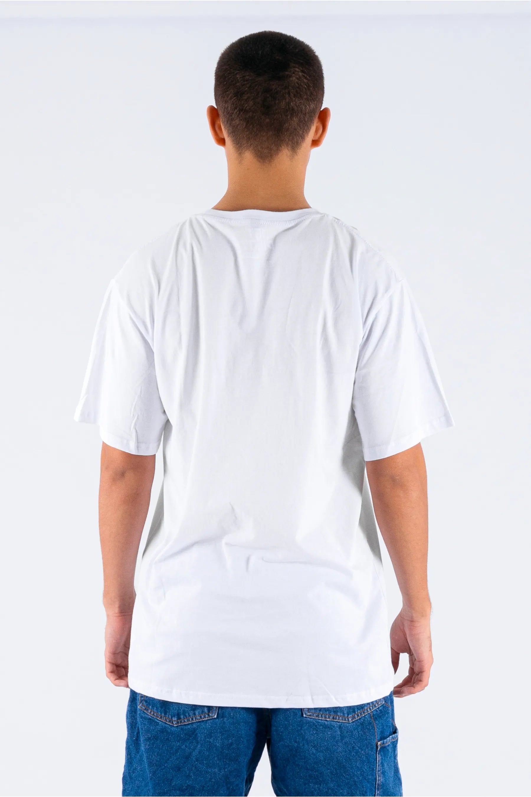 Back view of a person wearing a white tee on a white background — view 2 (3)