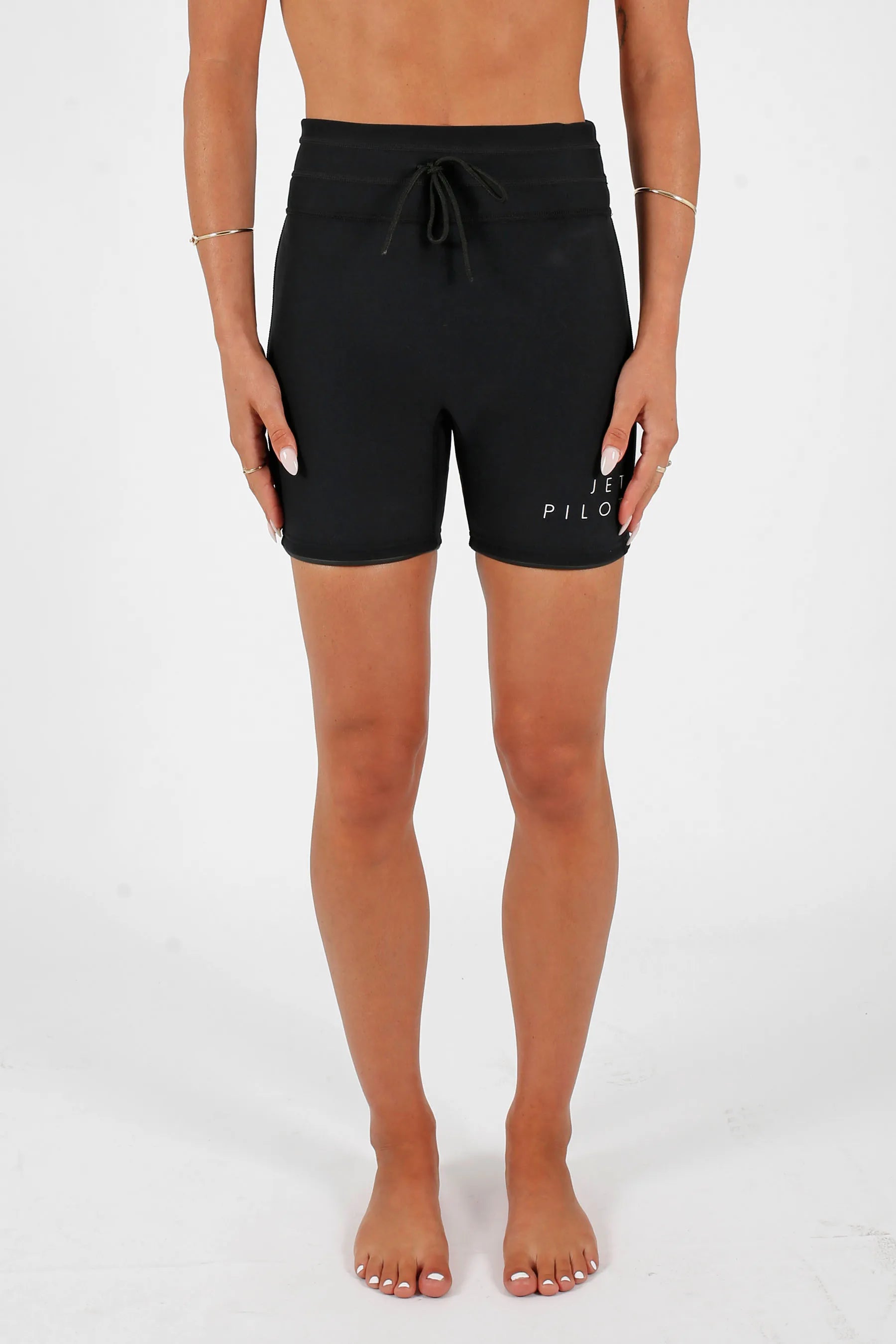 Person wearingJetpilot Corp 5" High Waisted Neoprene Short - Black on a white background — image 2