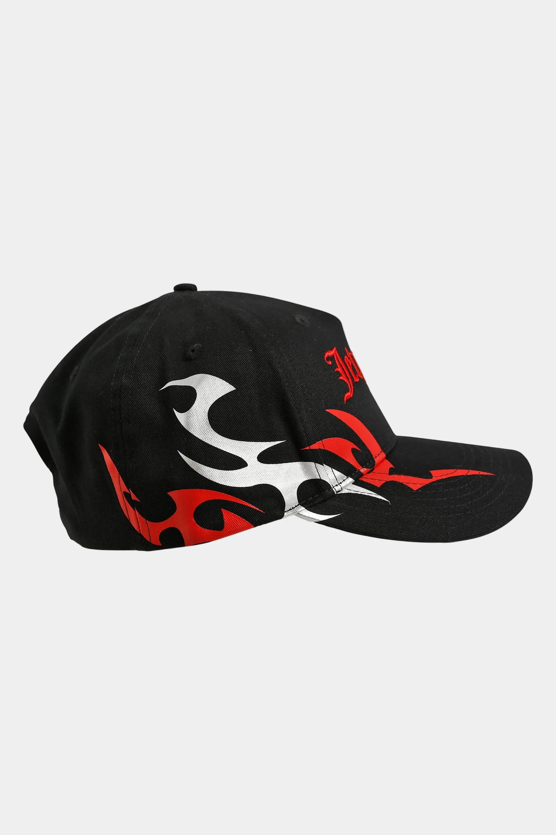 Black cap with red and metallic grey tribal designs on a light grey background