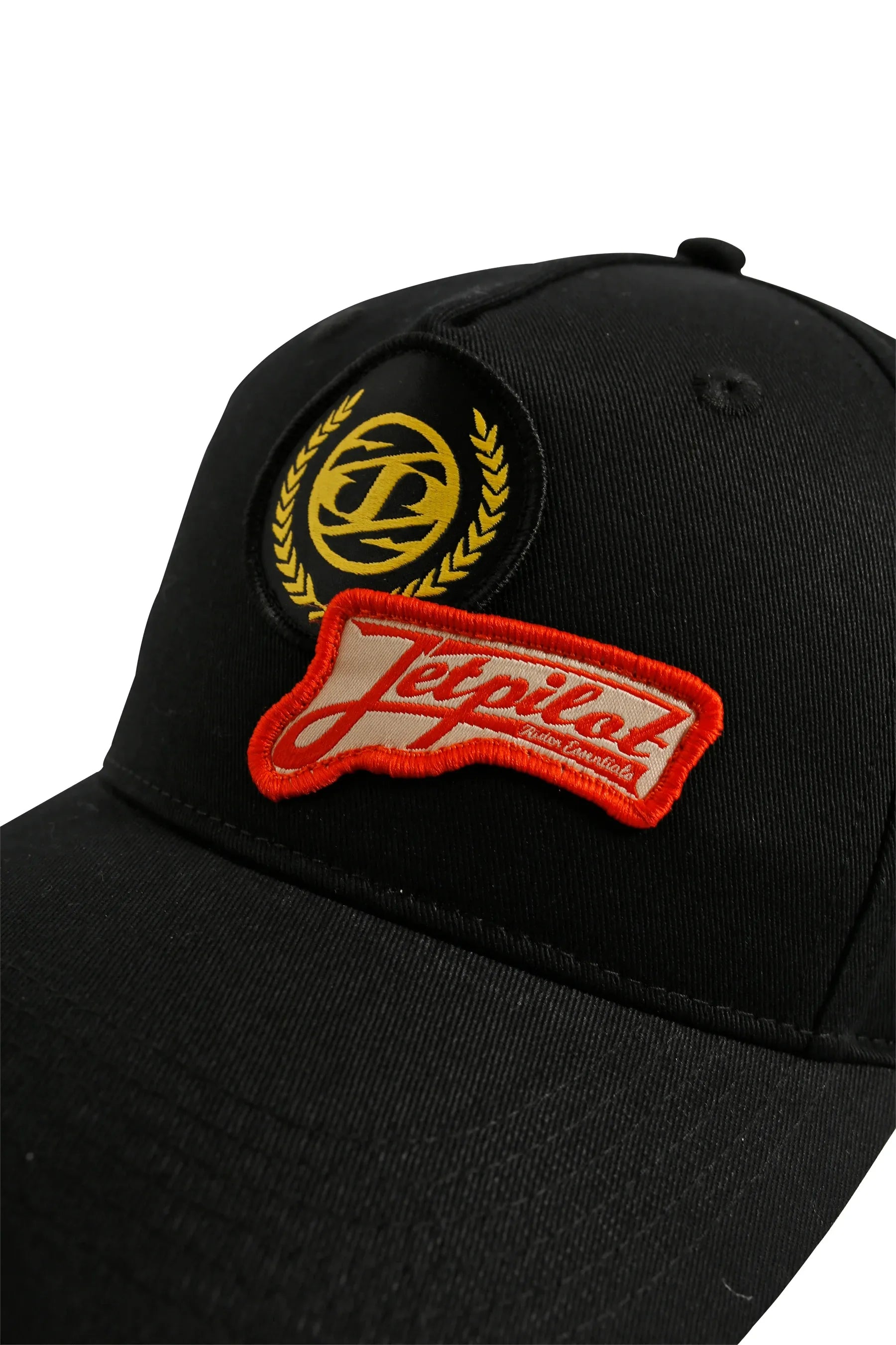 Black cap with a red and yellow patch on a white background