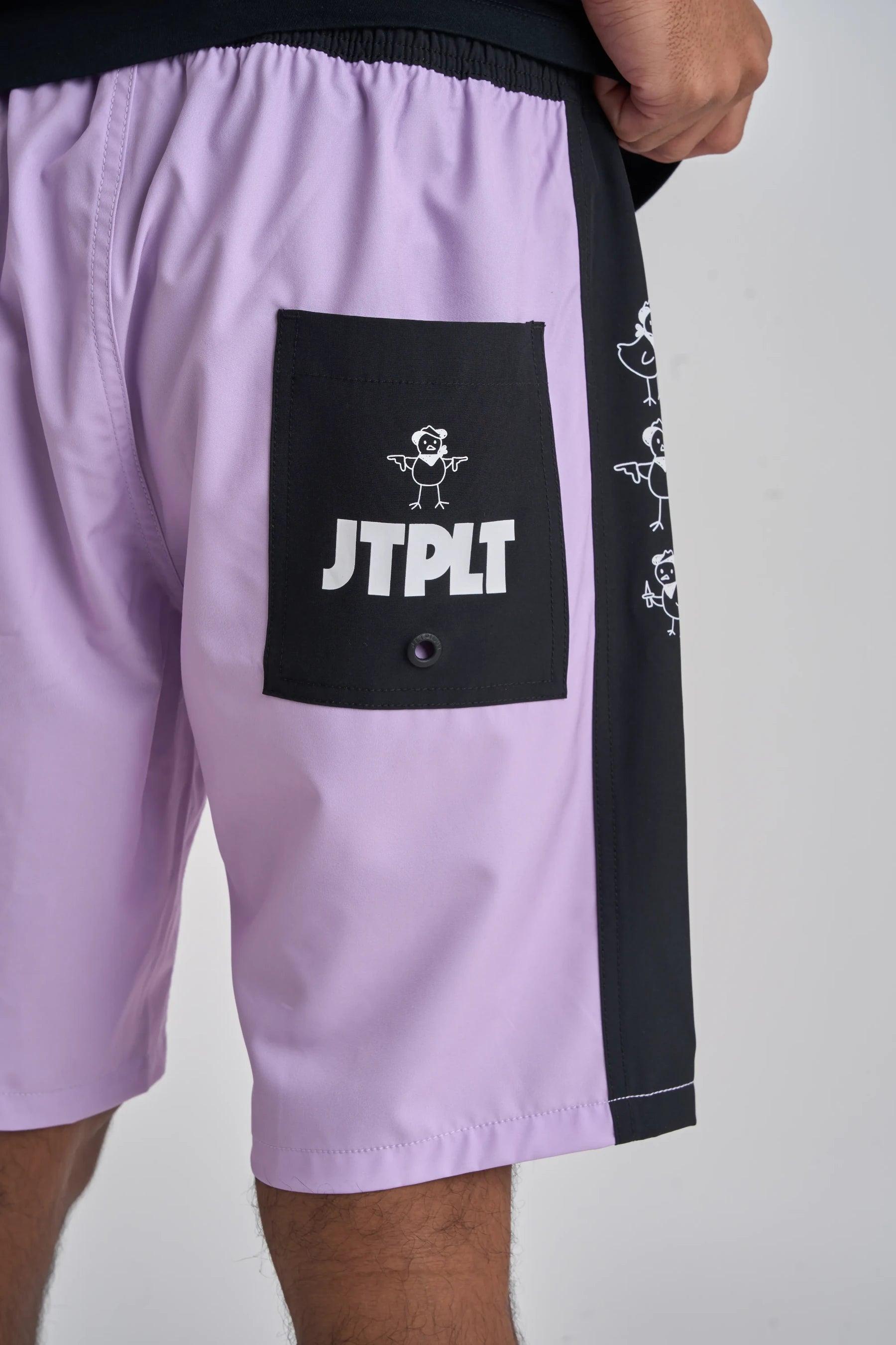 Purple shorts with a black pocket featuring 'JTPLT' logo on a white background