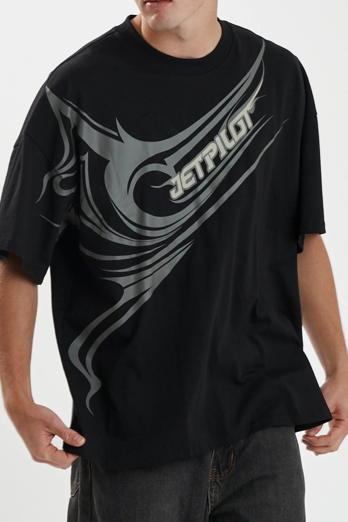 Close-up of the grey print wrapping from chest to sleeve on the black Sinister Tee