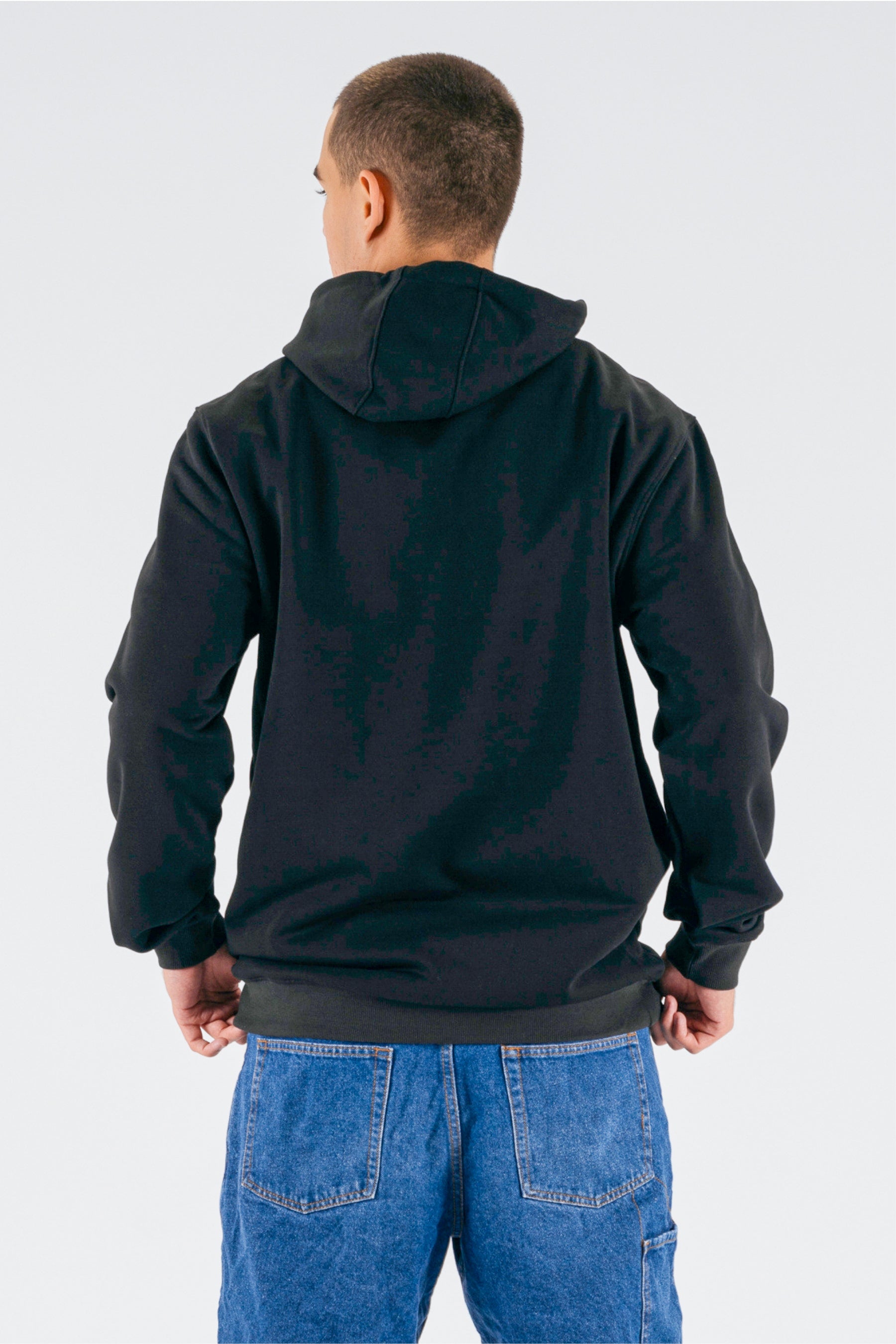 Back view of a person wearing a black pullover on a white background — view 2 (3)