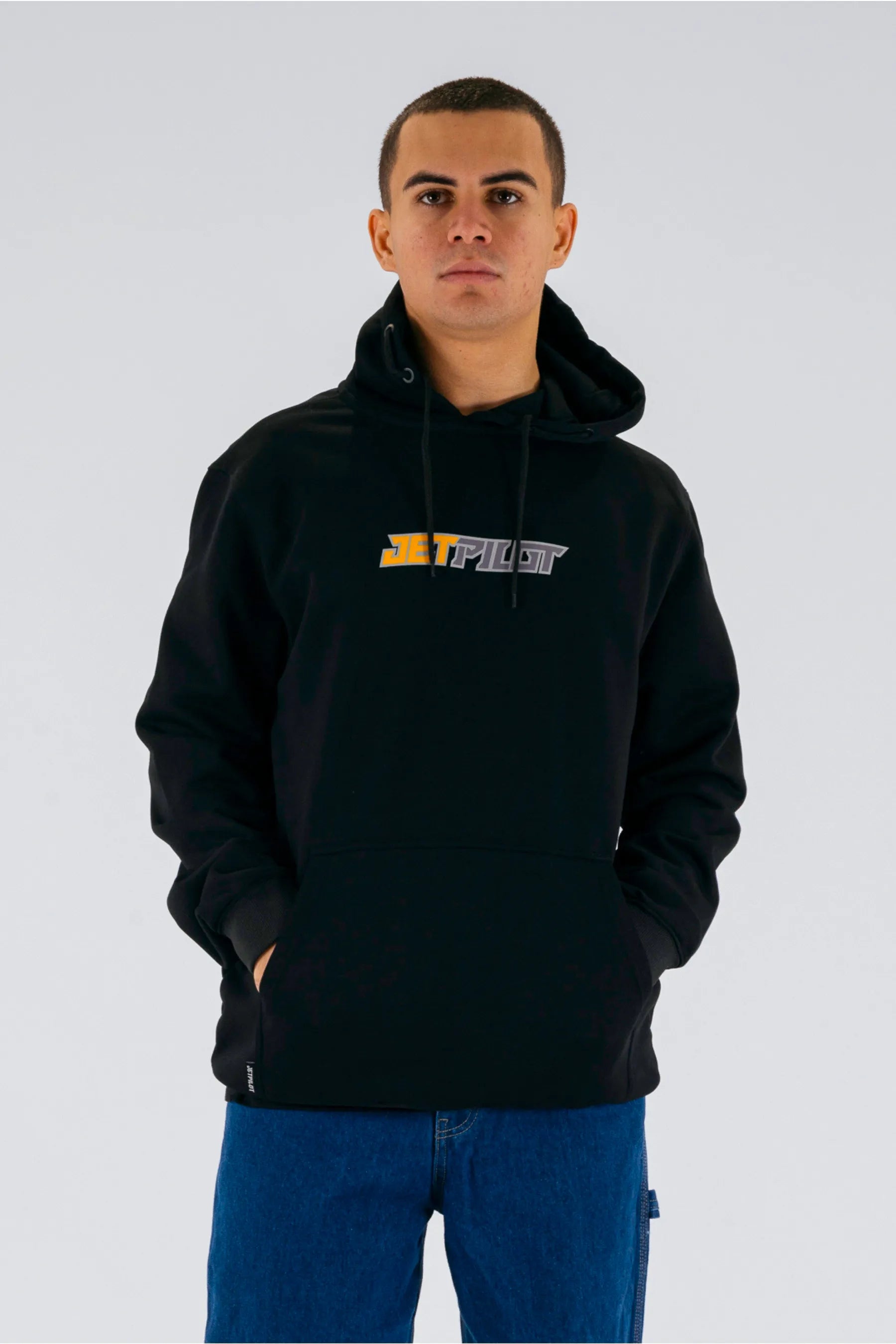 front view of a person wearing a black pullover with a Jetpilot logo on a white background — view 1 (7)