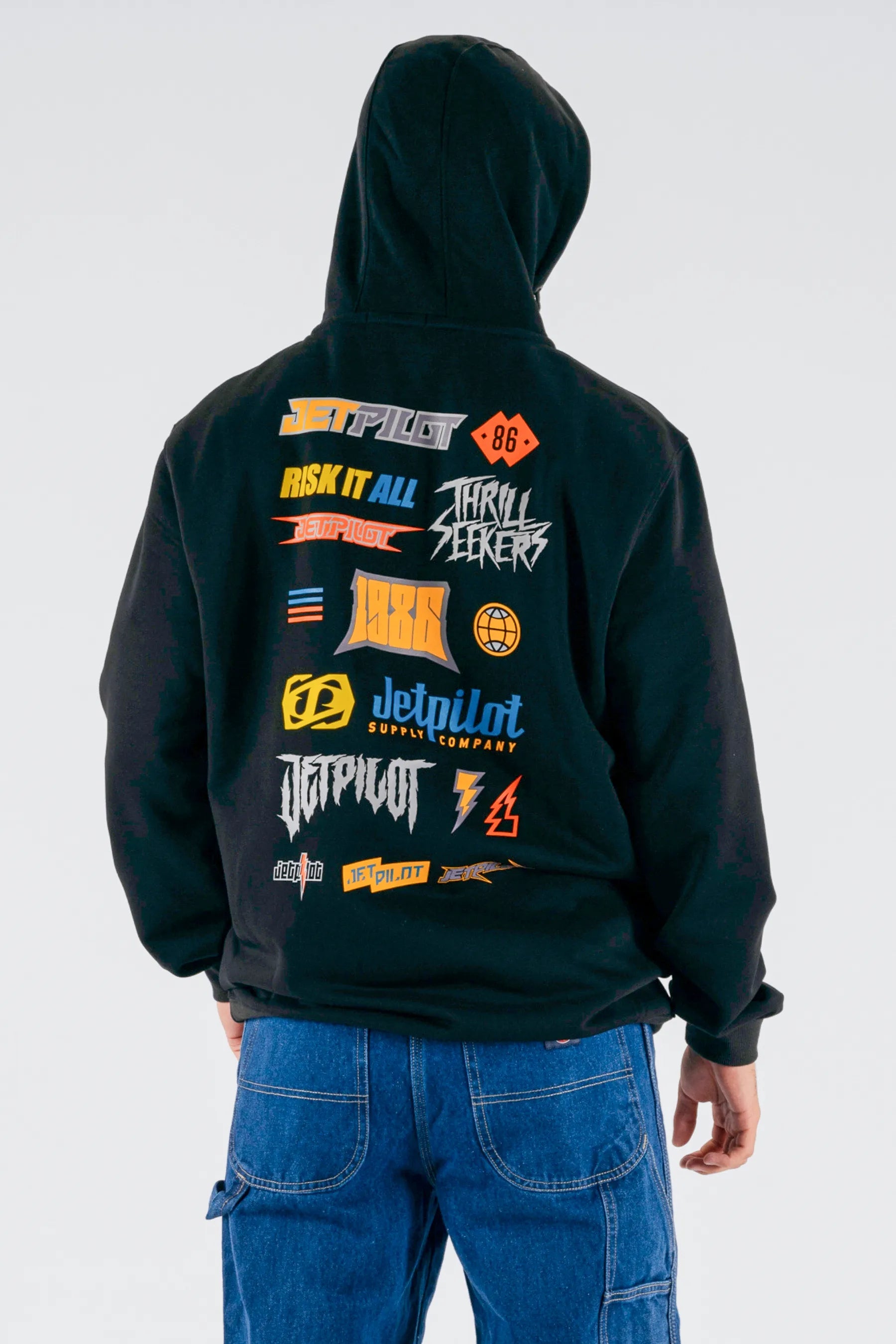 back view of a person wearing a black pullover with a Jetpilot logos on a white background — view 2 (7)