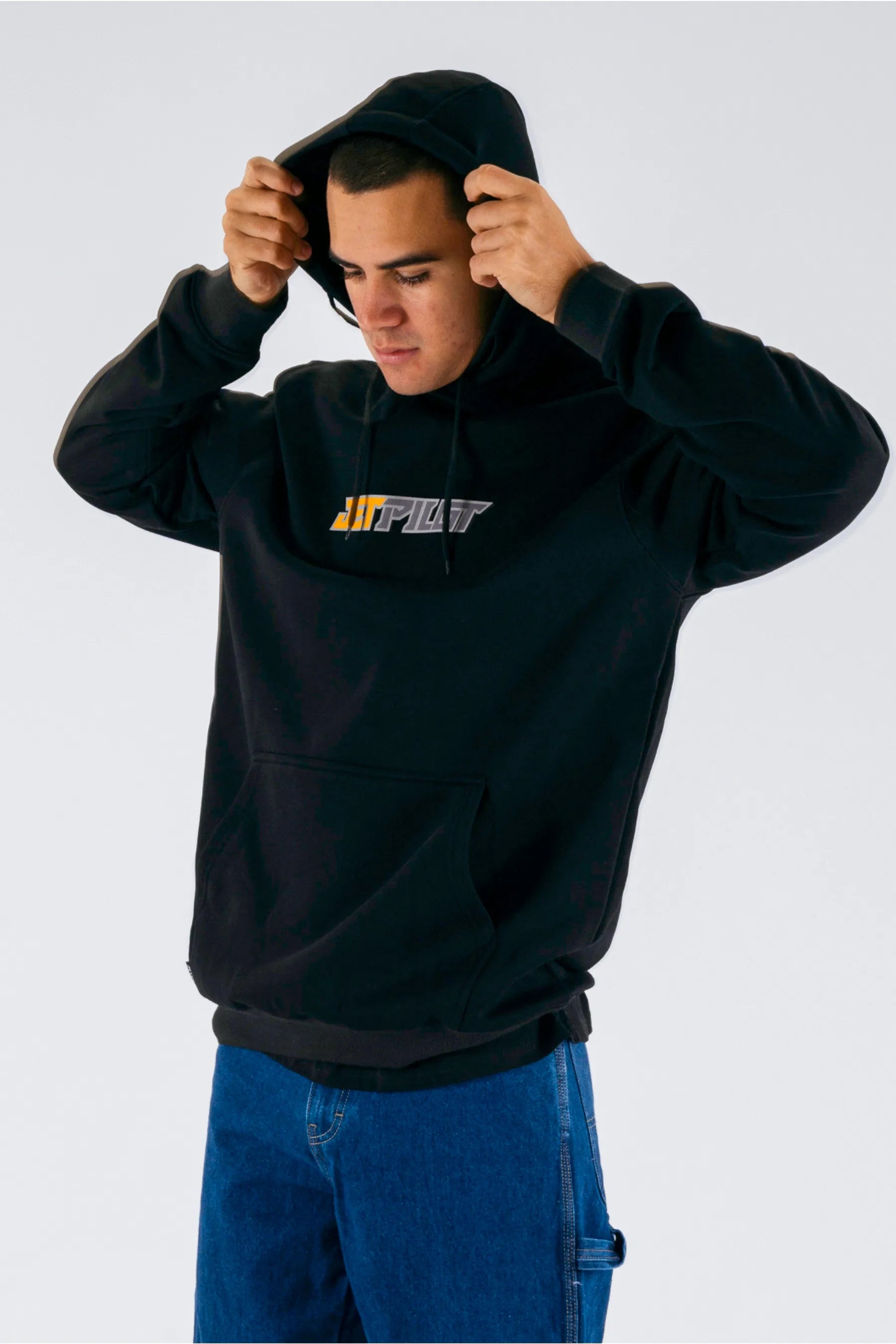 a person wearing a black pullover with a Jetpilot logo — view 4 (7)