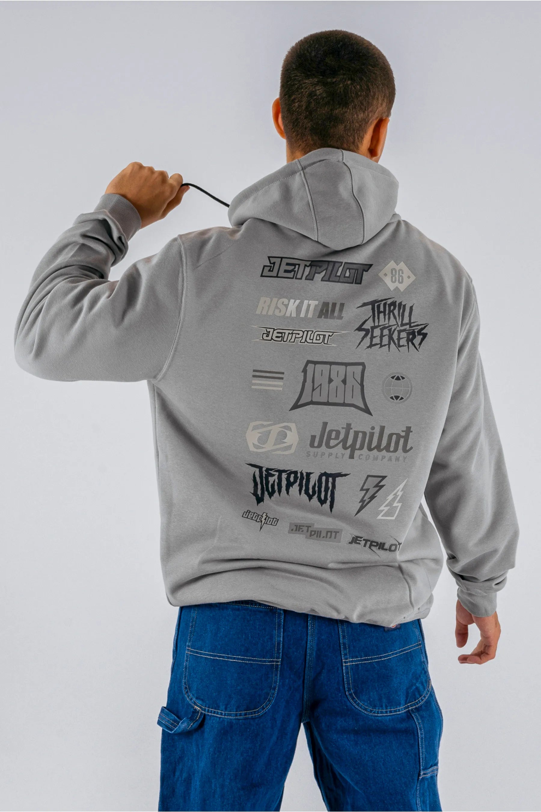 back view of a person wearing a grey pullover with a Jetpilot logos on a white background — view 2 (3)