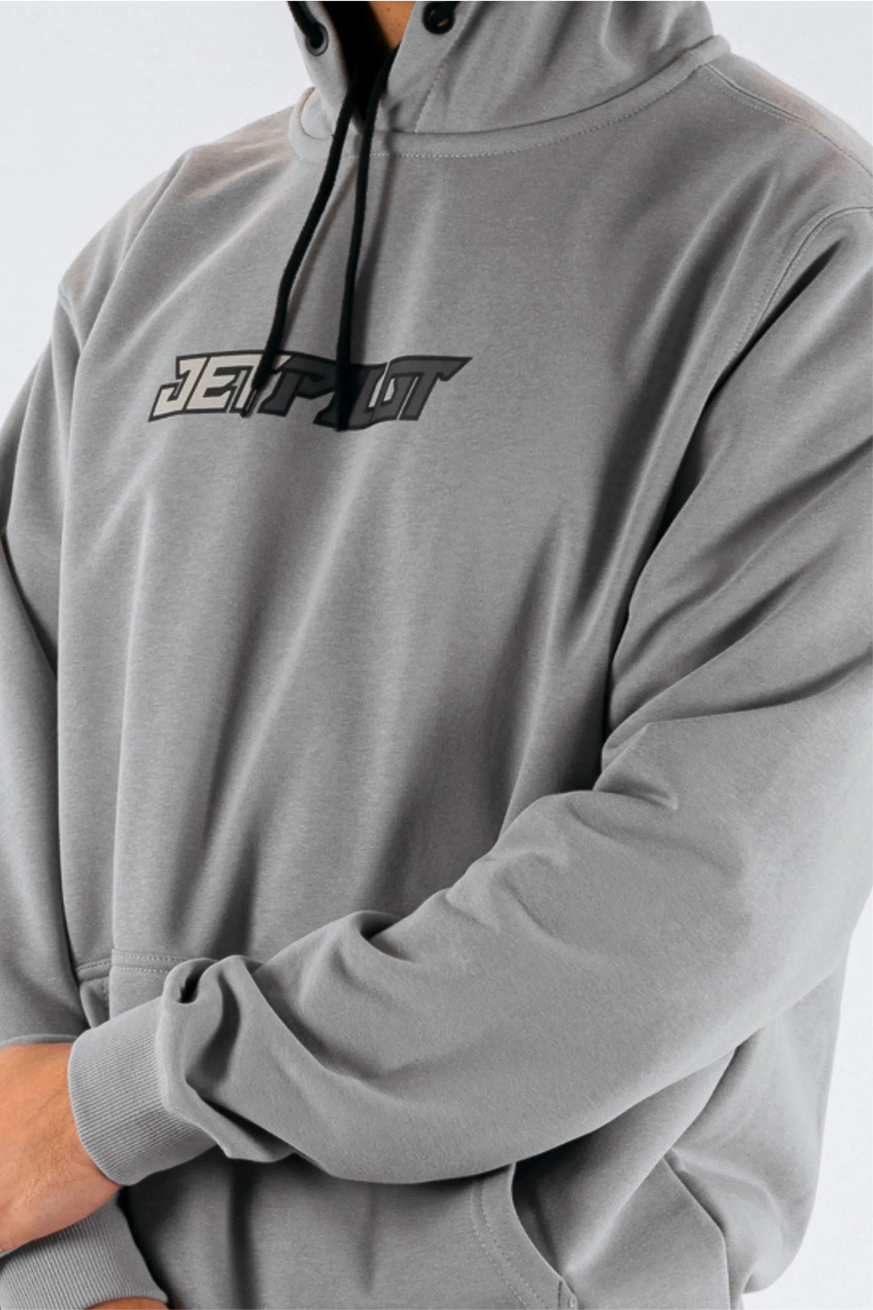 close up of a person wearing a grey pullover with a Jetpilot logo on a white background — view 5 (3)