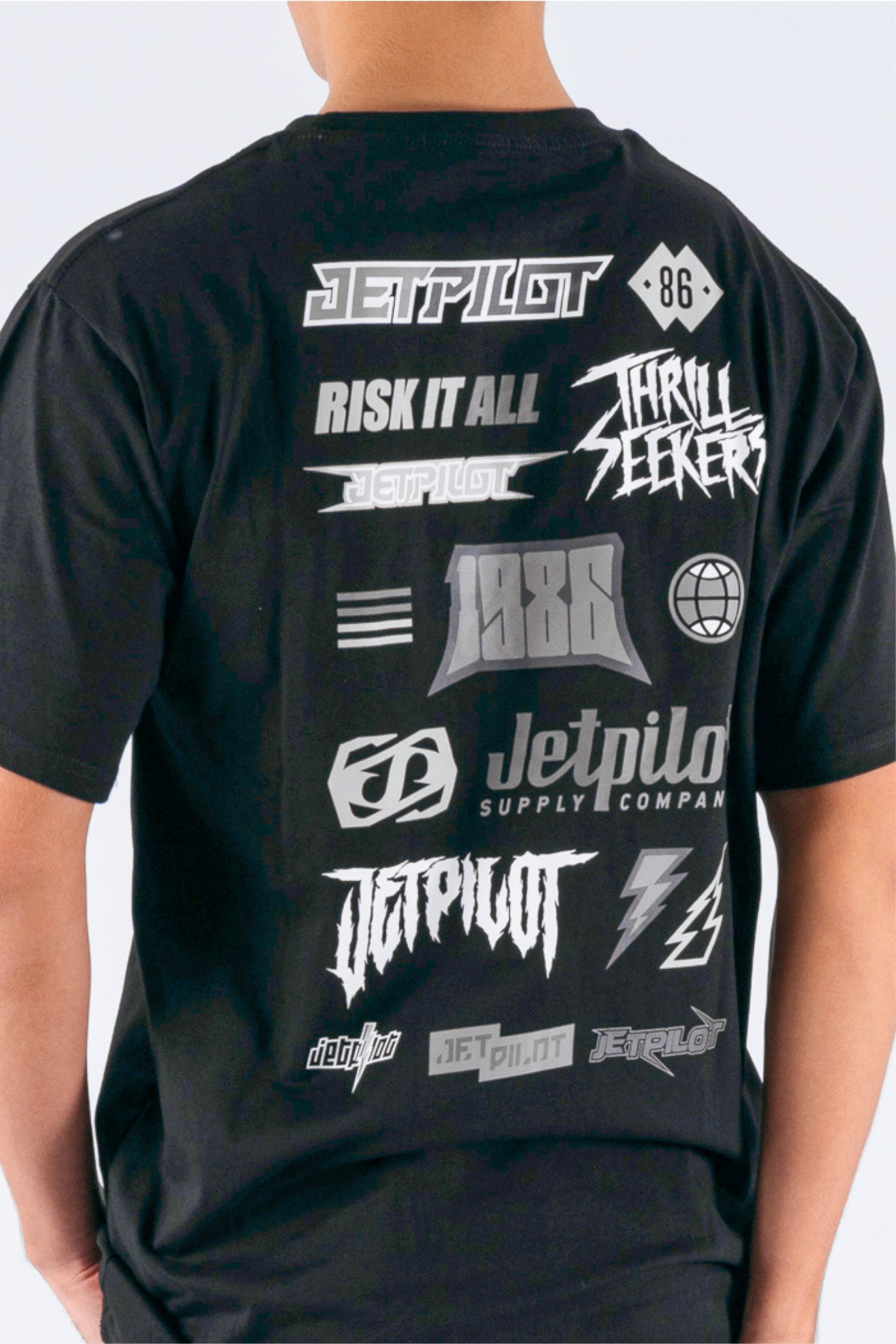 back close up view of a person wearing a black tee with the Jetpilot logos on a white background — view 5 (3)