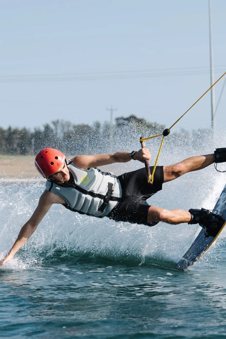 Person wakeboarding on a body of water with a clear sky — image 2