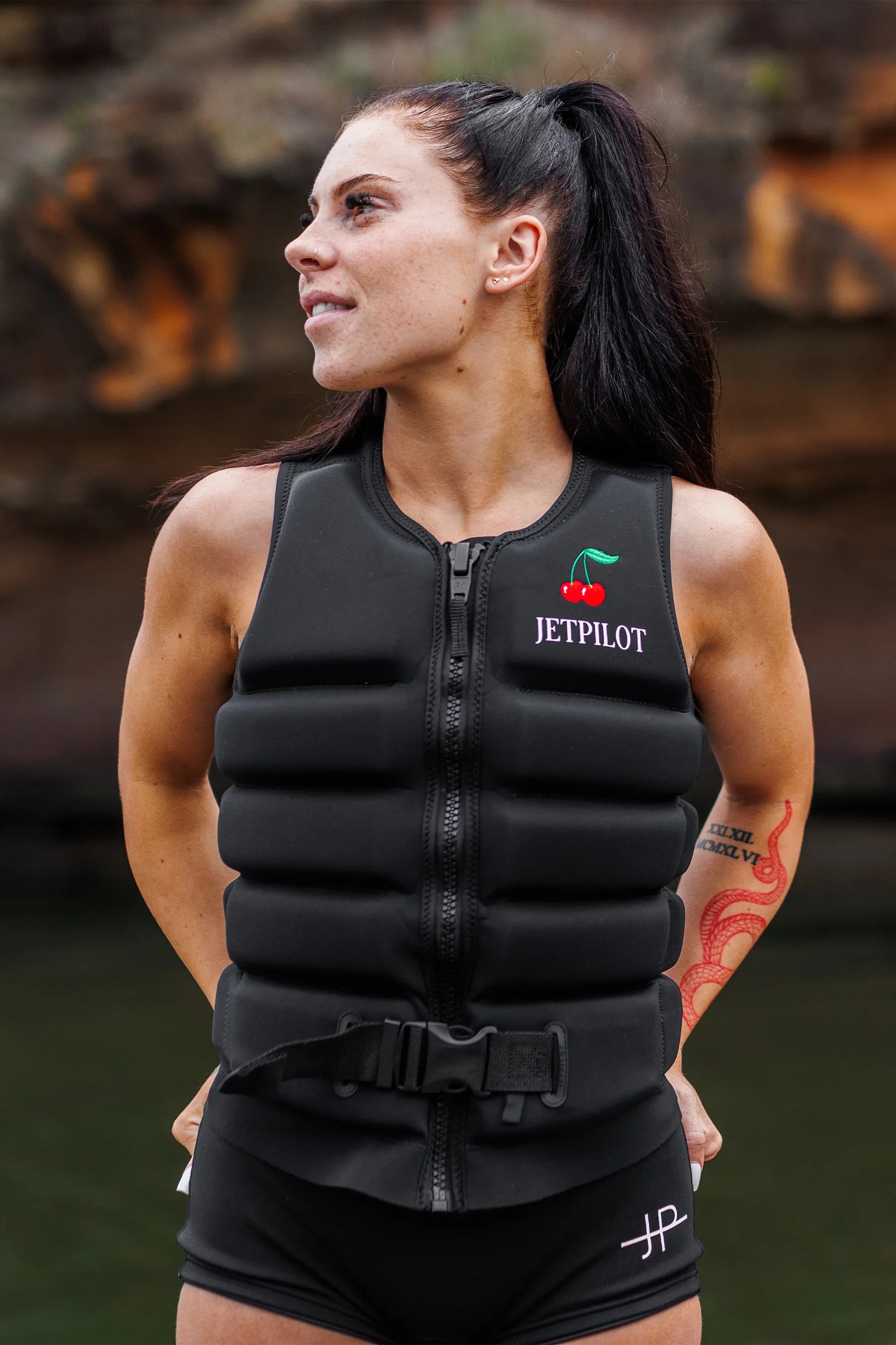 Woman wearing a black Jetpilot life vest outdoors