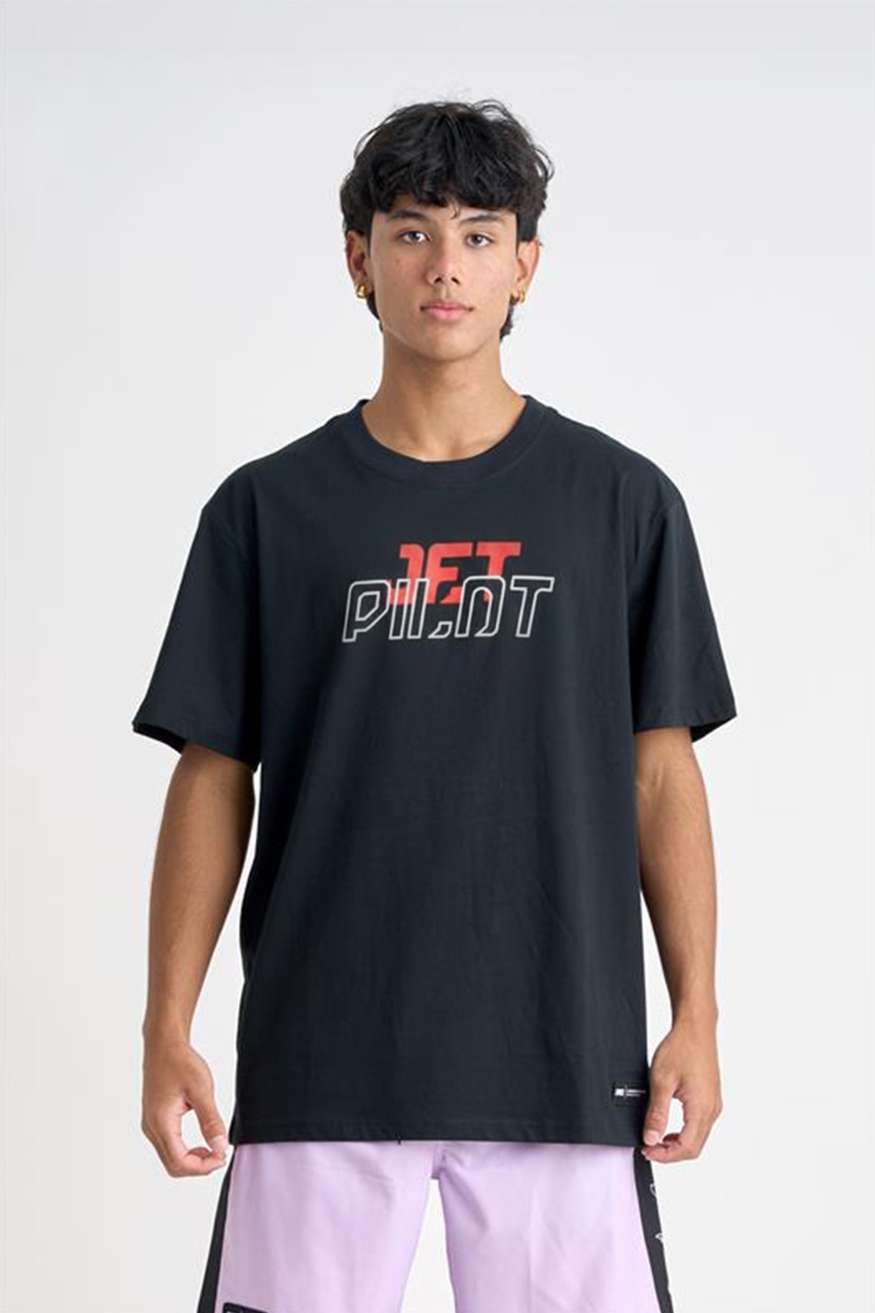 Person wearing a black t-shirt with red and white text on a plain background — image 2